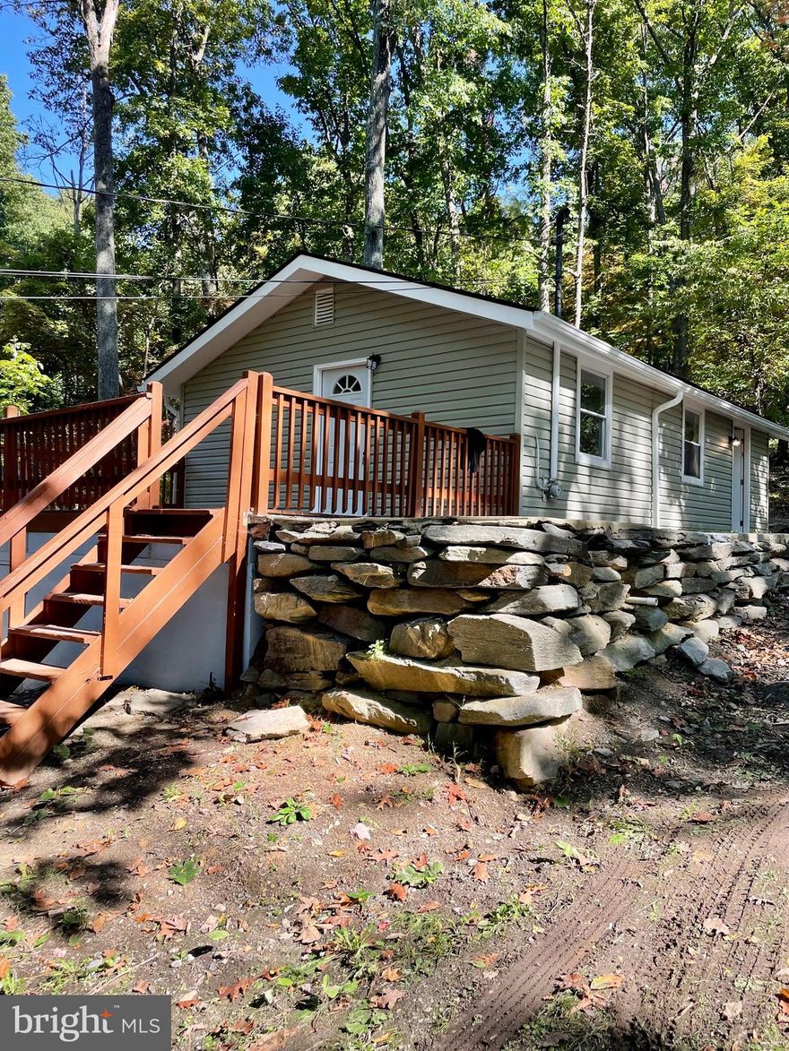 Newly renovated, cute 1 bedroom bungalow on the mountain!  This home includes a new roof, vinyl siding, heat pump, kitchen, bathroom, LVP flooring, and more!  The kitchen offers white cabinets with quartz countertops and brand new stainless steel appliances.  Just sit on the front deck and listen to the birds!  
Could make a great AirBnB, VRBO vacation rental or weekend getaway!  This neighborhood backs up to the Appalachian Trail and is minutes from downtown Harpers Ferry and Harpers Ferry Brewing and 340.  Has public water.  It is believed to have high speed internet.  The community has a fishing pond stocked for the community.  Agent is owner,