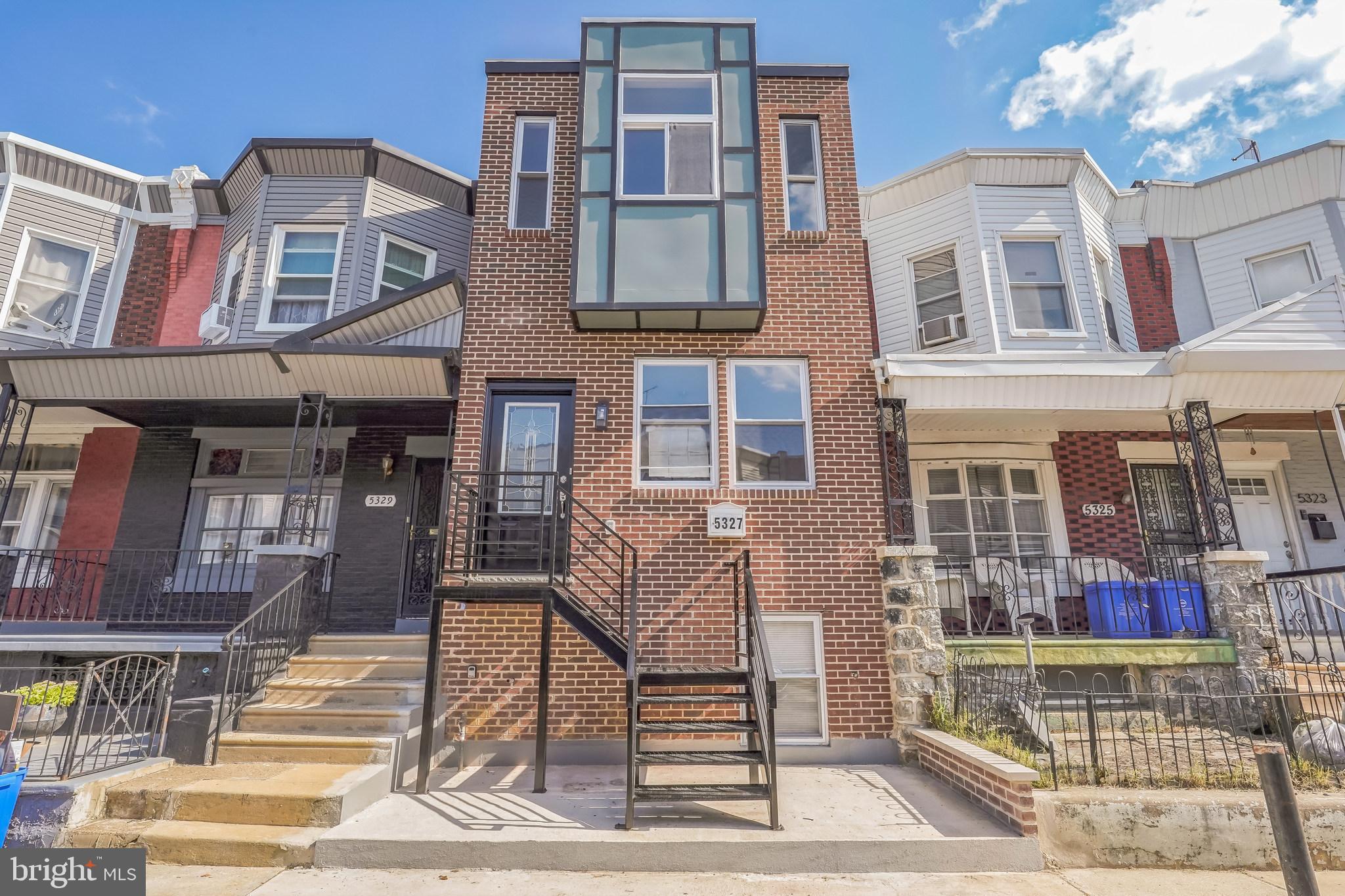 Brand-new construction at 5327 Chancellor Street in the Walnut Hill section of Philadelphia, offering 4 bedrooms, 3 bathrooms, and approximately 1,800 square feet of thoughtfully designed living space. Built from the ground up, this home combines modern architecture with the latest in comfort, efficiency, and style. The open main level welcomes you with a spacious living and dining area featuring recessed lighting, gleaming hardwood floors, and a striking open-riser staircase that adds a sleek, contemporary edge. The gourmet kitchen is a centerpiece, boasting white shaker cabinetry, quartz countertops, stainless steel appliances, a center island with gas cooktop, and a stylish glass subway tile backsplash. Double French doors open to a private, fenced rear patio—ideal for entertaining, dining al fresco, or enjoying a quiet evening outdoors.
Upstairs, the primary suite offers a private retreat with a large closet and a spa-like bath featuring a frameless glass shower, rainfall head, gold fixtures, and marble-style tile. Three additional bedrooms provide flexibility for family, guests, or home office use, and are served by modern baths with quartz-topped vanities, designer lighting, and illuminated mirrors. A convenient second-floor laundry area enhances everyday living.
The fully finished lower level expands your options with versatile space perfect for a media room, gym, guest suite, or playroom, complete with its own full bath. Built with energy-efficient windows, modern lighting, and all-new electrical, plumbing, and HVAC systems—including central air and gas heat—this home is ready for years of low-maintenance enjoyment.
Move-in ready and ideally located near public transit, parks, shopping, and University City amenities. Special financing options may also be available, including a $10,000 Home Access Grant for qualified buyers with income up to $101,160, the Dream Home Plan with just 3% down, and a $5,000 closing cost credit for buyers with income up to $67,440. Eligible buyers may qualify for both programs, making this home even more attainable.