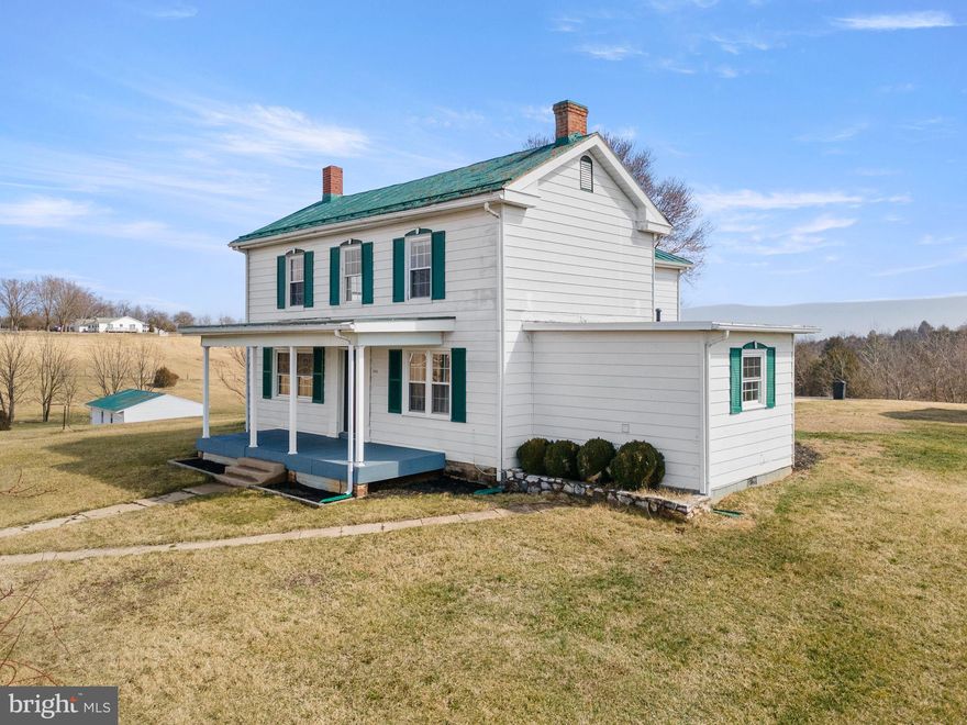 Gorgeous 2,500+ Sq Ft 4 BR 2BA Farmhouse on 6 lovely Acres and 360 degree Mountain Views! Make this property your Dream Farmette! Beautiful Original Heart of Pine Wood Floors, Master Suite on Main Level, and a Covered Front Porch! Dining Room has lovely Bay Windows letting in tons of natural light! Upstairs features three additional bedrooms, Full Bath with walk-in shower and a claw foot soaking tub. Nicely Updated Kitchen with Stainless Appliances, New Gas Furnace, and and Outdoor Wood Stove for a Second Supplemental Heat Source! Paved Asphalt Driveway, 26'x40' Detached Garage/Workshop with Electric, Concrete Floors and 10' Front Loading Bay. 700 sq ft Rustic Little House behind the main house has tons of potential! This property would make the prefect Homestead for you and your family. Come Live surrounded only by a Vineyard, Farmland, and endless Mountain Views!
