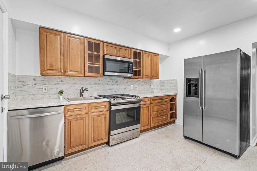 This beautiful end unit row-house has been fully renovated, Ready to move in, this home has 4  spacious bedrooms, 1.5 baths. updated kitchen with backsplash and all stainless-steel appliances! The basement is unfinished perfect for storage. This home features recessed lights through out the house, washer and Dryer included. The back yard is fully fenced. Scheduled your showing now!!