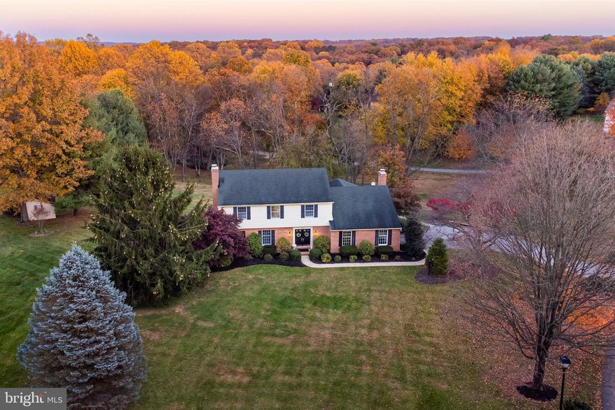 Statuesque colonial property on 1.77 scenic lot along the Falls Rd Corridor. The main level welcomes you at the formal vestibule, gleaming solid hardwood floors, leading into a spacious living room with beautiful marble wood-burning fireplace mantle, separate dining room with custom moldings, as well as an eat-in kitchen with solid wood cabinets, granite countertops, and  brand new stainless steel appliances (just installed). Cozy family room with custom built-in bar and another beautiful brick wood-burning fireplace, will lead you out into the screened-in porch, a perfect space for watching the picturesque views of your property in its glory -  sunrises and sunsets. Second floor will wow you with gleaming hardwood floors, spacious rooms, including an amazing master suite with a spa-like bathroom with a custom walk in shower and beautiful italian tile.  Lower finished level is perfect space for a recreation room or play area.  Huge deck is perfect space for family gatherings and cookouts. NEW high efficiency HVAC system.
