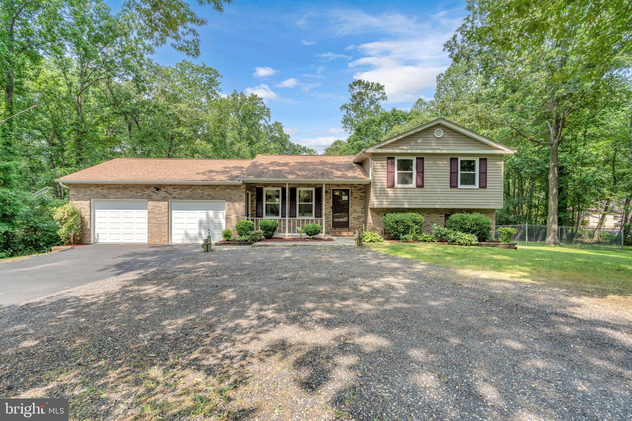 Buyers financing fell through, their loss is your opportunity to own this 4-level home situated on 3.57 partially cleared acres! Features 4 bedrooms, 3 full baths, and a 2-car garage with plenty of additional parking. The main level offers a living room, kitchen, and dining area. Upstairs includes a primary bedroom with private en-suite bath, plus two additional bedrooms and a second full bath.
The first lower level has a large family room with fireplace, a fourth bedroom, third full bath, laundry room and separate entrance—perfect for in-law suite or guest space. The second lower level is unfinished and ideal for storage or future expansion.
Outdoor highlights include multiple storage sheds, a fenced portion of the yard, and wide-open usable land—perfect for pets, hobbies, or recreational use. Plenty of room to grow, relax, and enjoy privacy. Located close to shopping, restaurants and more, easy commute to the DC metro area but away from it all!