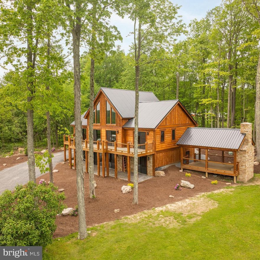 "Unrivaled year-round lake views!!!  Designed with remarkable craftsmanship, this brand-new, 4-bedroom home offers an open and inviting floor plan delivering a truly unparalleled living experience in the highly sought after Bray Run community.  Upon entering, you are greeted with a dramatic wall of glass showcasing the incredible four-season panoramic views of Deep Creek Lake and the surrounding mountains.  Soaring cathedral wood ceilings and a grand natural stacked-stone fireplace create a warm and cozy atmosphere on the main level.  A modern kitchen with granite countertops, stainless steel appliances, and a custom-made island opens to the spacious dining room for gathering with family and friends.  An expansive deck provides additional space for outdoor entertaining and enjoying the serene, nature-filled surroundings.  You can retreat in the luxurious master bedroom ensuite, containing a spacious walk-in closet and elegant master bath with a custom-built tiled shower and premium fixtures.  Upstairs, an open loft is ideal for a game room, lounge, or home office.  On the lower level, 3 additional bedroom ensuites offer both privacy and tranquility.  The home’s picturesque charm shines in the spacious family room with its own stacked-stone fireplace.  A stylish powder room and oversized storage/mechanical room complete the lower level.  The gently sloping lot is perfectly suited for the home’s walkout basement, maximizing living space on the beautiful stamped-concrete patio.  Step outside to enjoy fresh mountain air under a custom-built covered pavilion featuring a stunning natural stone, wood-burning fireplace, perfect for creating outdoor memories in any season.  Crafted with the highest standards in design and construction, other noteworthy features include a main-level laundry room, central air conditioning, and a sprinkler system throughout. The Bray Run subdivision offers a private and picturesque recreational area with a playground, basketball/sports court, and scenic walking paths along Bray Run stream.  Other community amenities include high-speed internet, cable, and lighted streets.  Located just minutes from Swallow Falls State Park, Fork Run Recreation Area, Wisp Resort, shops and restaurants, this home offers the perfect blend of privacy, elegance, and accessibility."