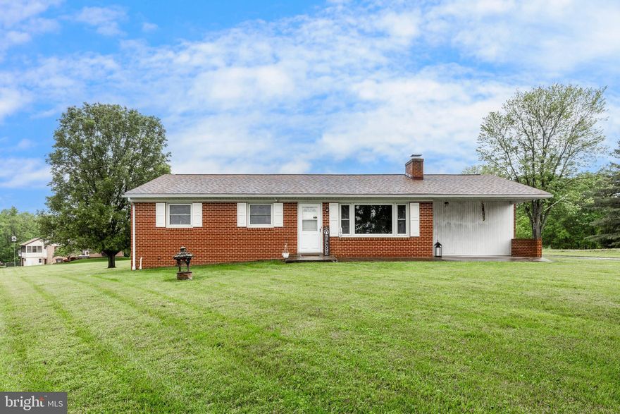 Cozy all-brick rancher nestled on 1.23 acres with 3 bedrooms and 2 baths. This home has been well maintained and offers a spacious country kitchen with island and dining area, living room with wood burning fireplace and large bay window for an abundance of natural sunlight. All 3 bedrooms have beautiful hardwood flooring, plus hardwood under the LR carpet as well. Enjoy the beautiful views and peaceful outdoors under the covered front porch or the covered deck in the rear. Additional features include main level laundry with custom cabinetry, whole house fan, newer architectural shingle roof, combined heat pump system installed, replacement windows. Plenty of storage between the unfinished basement, shed, and pull down attic stairs in the garage. Don't miss this opportunity to live out in the heart of Carroll County!