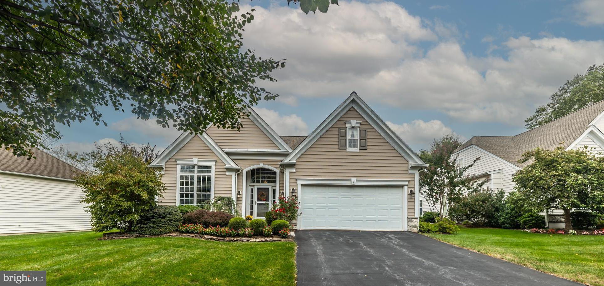 Welcome to Traditions. A sought after 55+ Gold Star Community. From the moment you arrive at this home, the pride of ownership is evident. Featuring 9' ceilings on the first floor and a two story open foyer with hardwood flooring which is continued through to the formal office, Kitchen and Family Room. The Formal living and Dining room are open and quite spacious. The Family room features a gas fireplace and wait until you see all the space in the kitchen and Breakfast room. There is a sliding door from the Breakfast room leading to the custom paver patio. This space is so lovely and made even more private as it is ringed with mature landscaping. Continue through to the light and airy Primary bedroom with ensuite Primary Bath. All this on the Main level for ease of living, along with a powder room and laundry room. Heading upstairs you'll find two bedrooms a full bath and open loft space. This is the perfec t spot for guests, grandchildren or a perfect quiet spot to read. Don't miss the walkin attic which serves as amazing storage space. Roof 2019,, HVAC with Humidifier 2020.All this and you are within walking distance to the Clubhouse and pool.