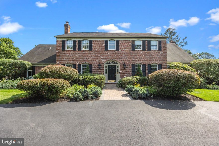 Experience the elegance of 1013 Cultipacker Road, where timeless architecture meets the comfort of modern living. Set on a beautifully manicured 1.2-acre lot in one of Yardley's most distinguished neighborhoods, Mirror Lake Farms, this stately brick-front colonial exudes grandeur from the moment you arrive. A circular driveway welcomes you to a residence that blends classic design with updated amenities across more than 3,600 square feet of living space.

Step through the front door into a gracious foyer where a sweeping staircase and detailed millwork set the tone. To the left is a spacious living room anchored with a wood-burning fireplace and on the right, a generous formal dining room, both detailed with custom trim, shadowbox wainscoting and hardwood floors. 

The heart of the home is the gourmet kitchen, designed to impress and perform. A massive 9-foot quartz island offers seating and prep space, paired with top-tier Thermador Professional appliances—including a 6-burner professional range and matching refrigerator and dishwasher. The white shaker cabinets, farmhouse sink, herringbone backsplash and window seat with hidden storage create both beauty and function. Entertain effortlessly from the adjoining wet bar complete with wine racks, mini fridge, ice maker, and display cabinetry.

The open-concept family room features a propane fireplace, flanked to the right by an elegant home office with French doors and custom built-in cabinets, and flows directly out to the backyard retreat. Out back, you’ll find a large deck and a covered patio that overlook the in-ground pool (new pool pump, filter and cleaning equipment 2024, new pool heater 2025) with spillover spa, all within a private, fenced-in yard and with plenty of additional green area to run and play. It’s a space designed for entertaining, relaxation, and outdoor living.

Upstairs, the oversized primary suite includes a flexible sitting area or workout nook, a spa-style bathroom with dual vanities, a soaking tub, a walk-in shower, and abundant closet space. The hall bath has been stylishly renovated (2024) and three large bedrooms provide plenty of closet space for family or guests. 

The fully finished basement extends the home’s usable space with a second wet bar, built-in shelving, and endless potential for media, play, or hobbies, and a 3-car garage with epoxy flooring is perfect for housing your autos.

Conveniently located near major transit routes to Philadelphia, Princeton, and NYC, and within the highly regarded Pennsbury School District, this home offers a rare opportunity to enjoy high-end living in a truly premier location.