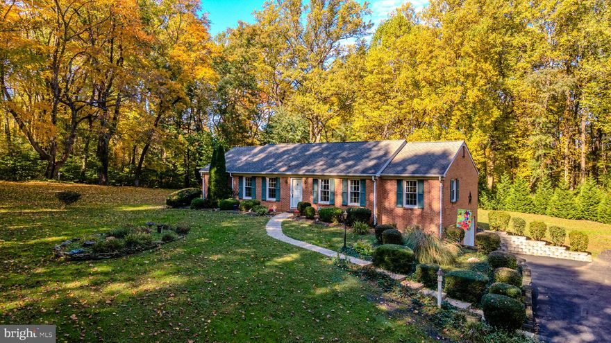 Are you looking for your own private and peaceful setting, look no further! As you drive down the 750' driveway you will love the setting for your new home which is surrounded by woods and situated on 3.38 acres. This spacious 3 bed, 2 bath rancher features a  first-floor family room w/hdw fl's, gas fireplace, country kitchen, formal living and dining rm's.  Also a primary bedroom w/WIC, an updated bathroom, 2 additional bedrooms, and a full bath. Finished lower level w/gas stove, laundry, and access to an oversized 2-car garage. Large deck off family room w/2 outside sheds.  Updates include replacement windows, whole house generator, architectural roof, heat pump, leaf filters in gutters, primary bathroom, well water conditioner and more! Don't miss this charming and lovely home, it won't last long!