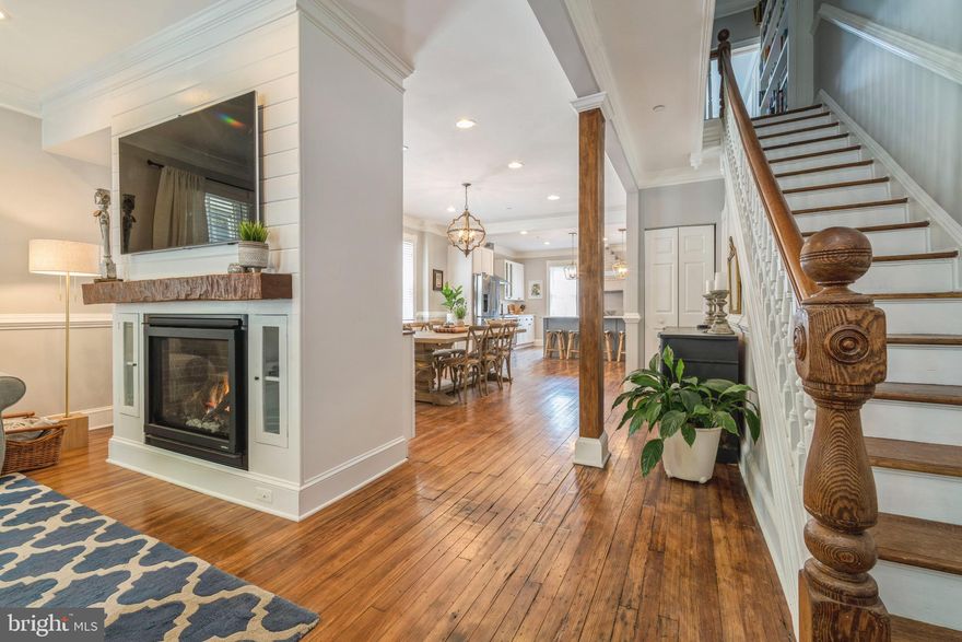 Remarkably renovated historic home in the heart of downtown Annapolis will provide you with every modern comfort while enjoying the luxury of walking through historic streets to restaurants and views of the bay. This home underwent a completed interior renovation in 2018, and several upgrades have been added by the current homeowner.  The entry foyer with original tile and architectural details welcomes you to a completely open concept home that retains historic charm and character..    The living room is the perfect gathering place with a gas fireplace, shiplap surround and wall mounted flat screen television.  The floor plan moves to a large dining/lounging area open to a gourmet kitchen.  A clean white and grey color scheme flows nicely throughout the main level, and highlights the beautiful kitchen cabinetry and countertops.  This is a fantastic space to hang out and create meals while family and visitors keep you company.   The kitchen has a separate beverage & bar center for entertaining, and retains the  original brick fireplace as a central decorative element.  The main staircase with original heavy newel post and rail is a testament to the craftsmanship of the period.   Upstairs you will find a  primary bedroom with exquisite finishes in the large en suite bathroom with double sink vanity and huge walk in shower.  There are two additional bedrooms on the second level that share another gorgeous bathroom.  The stacked front loading  laundry is also located on the second  level.  All of the bedrooms have large original windows that allow for plenty of natural light. The entire third level of the home features an additional primary suite, and another beautiful bathroom with both a large walk in shower and soaking tub.  There is  a cozy additional seating area here as well, providing space for an  addition television room  or relaxing reading space  while appreciating the rooftop views from the windows.  This home is a rare find set in a historic setting while offering a high end modern interior and newer systems.  No "to do" list of interior renovations will be needed here, you can just move in and immediately start enjoying all the charms of living  the downtown Annapolis lifestyle!