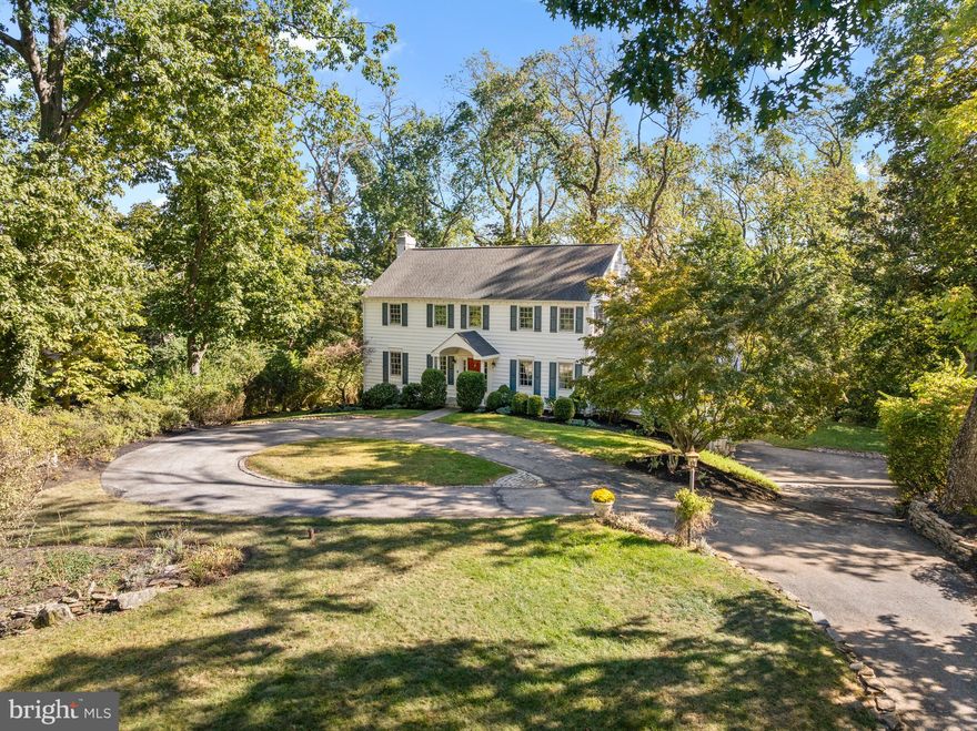 Welcome to 217 Jeffery Lane in the highly desirable Greene Countrie neighborhood of Newtown Square. Tucked within one of the community’s most beautiful settings, this home enjoys a unique position on a street that gracefully connects two cul-de-sacs, giving it both a welcoming presence and an unmistakable sense of privacy. As you approach, the mature landscaping and gentle elevation create an elegant arrival, setting the tone for the warmth and sophistication that unfold inside.

Upon pulling into the circular driveway, this classic beauty with white siding and navy shutters comes into view—its timeless exterior perfectly complementing its graceful position on the lot. The curb appeal is simply captivating, offering a picture-perfect blend of charm and understated elegance.

From the moment you enter the center hall Foyer, a sophisticated presence is immediately felt, as the home exudes balance, light, and warmth. The Living Room and Dining Room flank the Foyer, each generously sized and ideal for entertaining or everyday living. Both rooms have been sophistically decorated, with walls and ceilings painted in the same moody tone, creating a serene and calming environment that effortlessly flows from one space to the next. The Dining Room seamlessly flows into the heart of the home, where gleaming hardwood floors carry you into a large, light-filled Kitchen that is both stunning and functional. Natural light streams through a breathtaking Palladian window, capturing the backyard setting and making you feel as though you are one with nature. The Kitchen is an entertainer’s delight, featuring a bar area, quartz countertops, a marble-topped island, stainless steel appliances, and a dramatic two-story breakfast area with a cathedral ceiling and skylights that bathe the space in light, creating the perfect blend of comfort and grandeur. From the Kitchen, you can access the expansive deck that hugs the entire length of the back of the house—an ideal spot for dining al fresco, morning coffee, or simply enjoying the serene surroundings.

The Family Room addition is a showstopper—anchored by soaring ceilings, custom built-ins, and a marble fireplace, it serves as the perfect connection between the formal spaces and the Kitchen. Designed with both scale and warmth in mind, this stunning room creates a natural gathering place for family and friends while maintaining the home’s timeless sophistication. A Powder Room and convenient Laundry/Mudroom complete the main level.

Upstairs, the Primary Suite is a private retreat featuring an ensuite Bath with a double-sink vanity, shower, and whirlpool tub. Three additional Bedrooms, all bright and spacious with outfitted closets, are serviced by full Bath in the hall.

The finished walk-out Lower Level offers an abundance of additional living space, including a recreation room, kitchenette, full Bath, and access to a slate patio surrounded by lush, natural landscaping. The two-car attached Garage is also accessed from this level, offering convenience and additional storage space.

With over 4,400 square feet of living space, this home provides the perfect blend of elegance and functionality for modern living. The nearly two-acre property is a tranquil oasis with multiple outdoor entertaining areas, including the expansive wraparound deck and lower patio.

Located in one of Newtown Square’s most coveted neighborhoods, this home offers the perfect balance of community and privacy. Greene Countrie is known for its gently winding streets, established trees, and proximity to Main Line conveniences—a short distance to award-winning schools, downtown Wayne, fine dining & shops at Ellis Preserve, and major highways. 217 Jeffery Lane is more than a home—it’s a lifestyle, combining timeless elegance, thoughtful updates, and a serene setting that invites you to make cherished memories for years to come.