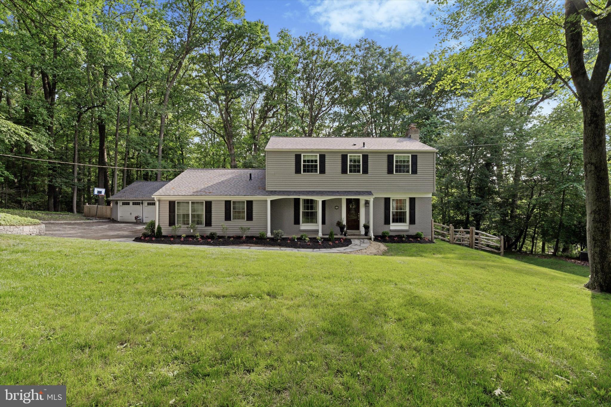 Welcome to 758 N. Valley Forge Road in Devon. This exceptional colonial boasts 2,470 square feet of luxurious above grade living space, five bedrooms, three full and one-half bathrooms, a partially finished basement, oversized two-car detached garage with covered breezeway connecting it to the home, a rear flagstone patio, and a 1.04-acre private lot abutting a 5-acre parcel owned by Jenkins Arboretum and Gardens. A brand-new flagstone walkway leads to the covered front entrance. First floor features includes: living room with exposed beams, wood burning fireplace, custom built-ins, and French door to exterior; dining room with elegant moldings, family room with triple window, built-in shelves, and exterior exit; stunning primary owner’s suite featuring accent wall with furniture grade moldings and backer, custom built-ins, walk-in closet with shelves and storage system, and a spa like bathroom offering a custom single bowl vanity with marble countertop, tile floor, and stall shower with frameless glass enclosure and premium plumbing fixtures; gourmet kitchen with custom cabinetry, granite countertop, stainless steel appliances, overhang seating for four, pendant lighting, and subway tile backsplash. Upstairs you’ll find three generously sized secondary bedrooms that share a recently renovated full hall bathroom along with another bedroom with ensuite bathroom. The partially finished lower level has an area current used as an exercise room but could also be a recreation room along with a pristine laundry room with pantry style closet doors. Other features and improvements include: flagstone rear patio and covered breezeway to garage, new fence (2024), new roof (2025), new air conditioning (2025), newer boiler (approx. 2021), fresh neutral interior paint, new front and rear landscaping, new hot water heater, custom drapes, ample recessed lighting throughout, circular driveway with ample parking, and refinished hardwood floors throughout most of the 1st and 2nd floor. This home has been meticulously maintained and tastefully improved over the past 9 years. It’s conveniently located close to all major commuter routes, the Septa Regional Rail, parks, trails, shopping, dining, and is part of the top rated Tredyffrin-Easttown School District.