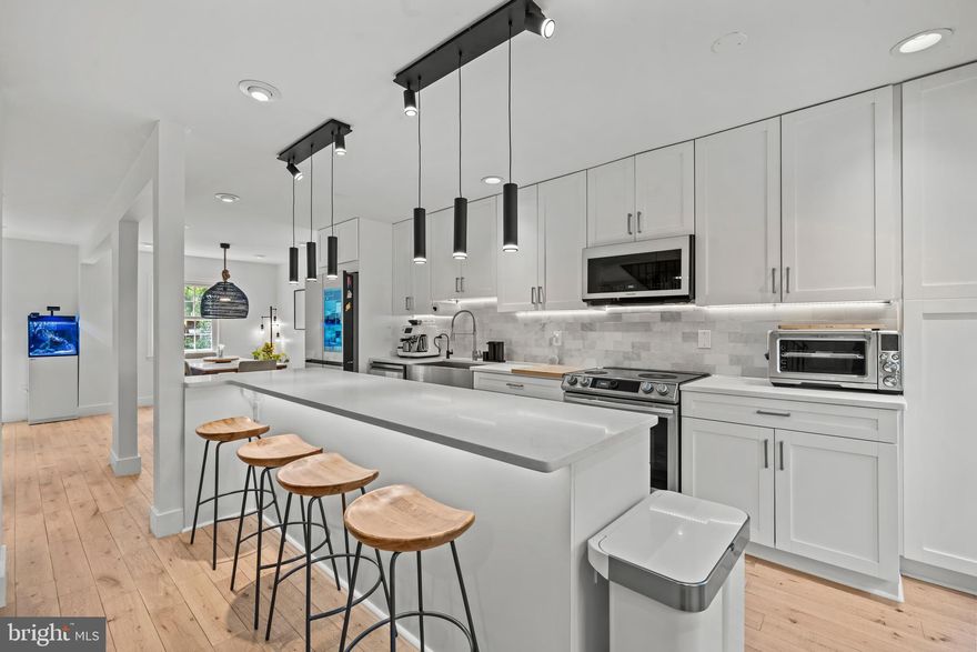 Very Motivated Seller! Bring all offers!  Stunning 4BR/3.5BA custom renovation with 2,200+ finished SF. Open floor plan with French oak hardwood floors throughout home, designer kitchen with oversized island, quartz counters, and high-end stainless steel  SMART appliances. Spacious primary suite with spa bath featuring freestanding tub, marble floors, and custom closets. Fully finished basement with LVP flooring, fully bedroom, full bath, electric fireplace, sound insulation, and additional laundry/fridge. Outdoor living includes new patio, synthetic turf, and fenced yard. Major upgrades: roof (2023, 50-yr warranty), HVAC & water heater (2018), fresh paint (2024), insulation, WiFi-enabled appliances, smart-home features, reverse osmosis filtration system, and HOA-approved EV charger. Move-in ready with every detail thoughtfully curated.