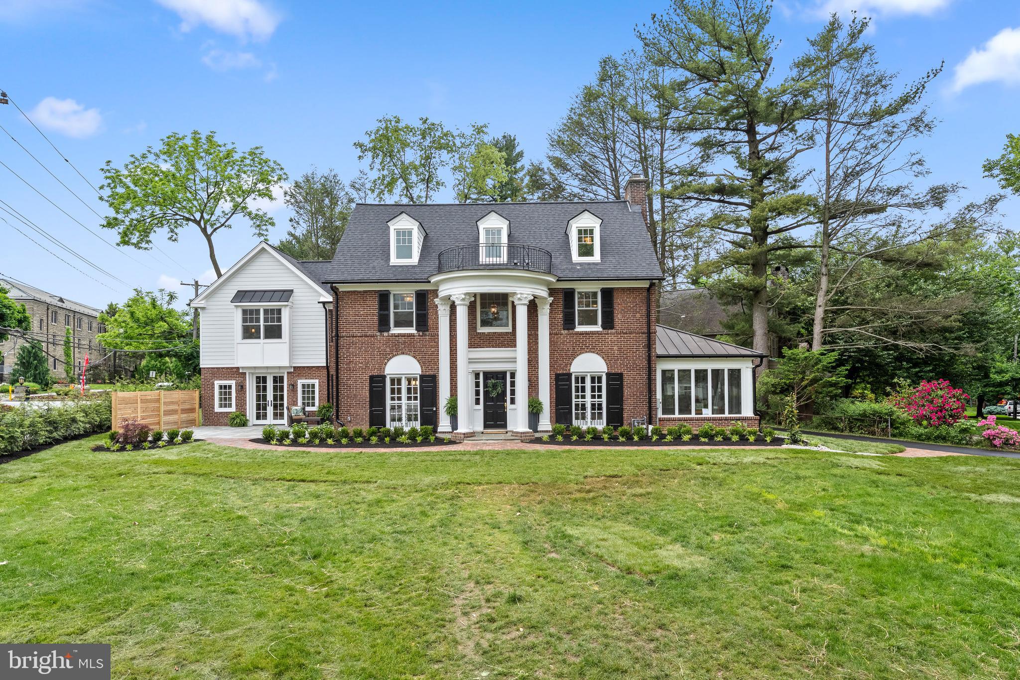 This fully renovated Villanova Colonial brings together the elegance of a classic Main Line estate with the comfort and efficiency of brand-new construction. The exterior makes an immediate impression with a stately brick façade, graceful columns, Hardie plank siding, a flagstone patio, and all-new hardscaping highlighted by a herringbone walkway. Inside, the home unfolds with a traditional yet open layout designed for today’s lifestyle. The welcoming foyer with a grand staircase is flanked by a formal living room with fireplace, custom built-ins, and French doors that open to a sun-filled bonus room ideal as an office, library, or play space. Opposite the foyer, the dining room offers an elegant setting for gatherings and flows seamlessly into the custom kitchen. The gourmet kitchen is the centerpiece of the home, featuring an oversized quartz island, custom cabinetry, a quartz backsplash, and high-end appliances including a six-burner stove. From here, the home opens into the expansive family room where oversized windows, a cozy window seat, and a gas fireplace create the perfect atmosphere. French doors lead directly outside to the flagstone terrace, offering effortless indoor-outdoor entertaining. The second floor boasts the primary suite, complete with vaulted ceilings, a custom walk-in closet, and a luxurious bathroom with dual vanities, soaking tub, glass-enclosed shower, and radiant heated floors. This level also includes two additional bedrooms, one with an ensuite bath, a marble-detailed hall bath, and a convenient laundry room. The third floor offers two more bedrooms and a full bath, perfect options for family or guests. Additional highlights include brand-new mechanicals, a four-zone heating system, an 80-gallon hot water heater, and a new roof. Thoughtful details such as recessed lighting, extensive millwork, solid red oak floors, and a mudroom entrance enhance the home even more. Situated in the heart of Villanova, this property offers proximity to the area’s finest dining and shopping, quick access to major roadways for an easy commute to Center City and New York, and located in the highly ranked Radnor School District with nearby access to some of the nation’s top private schools. Blending modern convenience with timeless character, don't miss out on this one-of-a-kind estate. Schedule your private showing today!