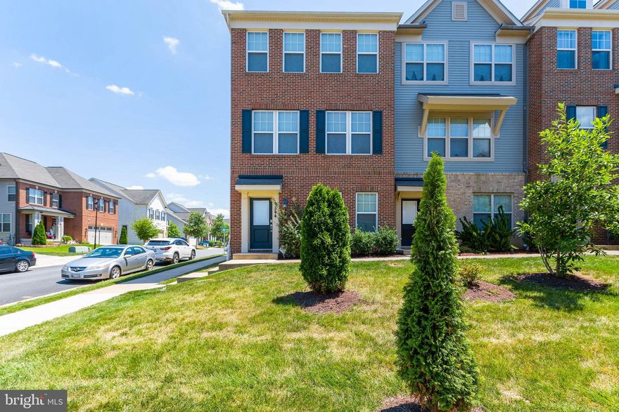 This “like new”, brick front, end unit home with keyless entry is turn-key ready and waiting for its new owners! Upon entering the foyer of the home, the adjacent lower-level family room has a majestic feel with columns that line the room. As you proceed up the stairs to the main level there is a powder room for your convenience.  Then you’ll enter the beautiful open kitchen and dining room where form meets function. The first thing you notice is the “end unit effect” and how much natural light there is! Next, you can't miss those beautiful gleaming hardwood floors. The kitchen is a chef’s delight with many decorative cabinets, a pantry, stainless steel appliances, and glistening granite countertops. The oversized granite island will surely be the focal point and accommodate many as you gather for food or fun! The abundance of overhead lighting will certainly brighten any mood! Anyone who loves to entertain will appreciate the large no-maintenance deck that is just waiting for your next family gathering or intimate wine down! On the upper level, there are three bedrooms each with plenty of space. The massive Primary Suite, with en suite bathroom, and walk-in closet even has a privacy window in the shower! The owner’s great taste is shown with matching cabinetry throughout the entire home and matching ceramic tile from shower to floor. You’ll appreciate the convenience of having your laundry room on the bedroom level. The oversized two-car garage has interior storage space and a side window.