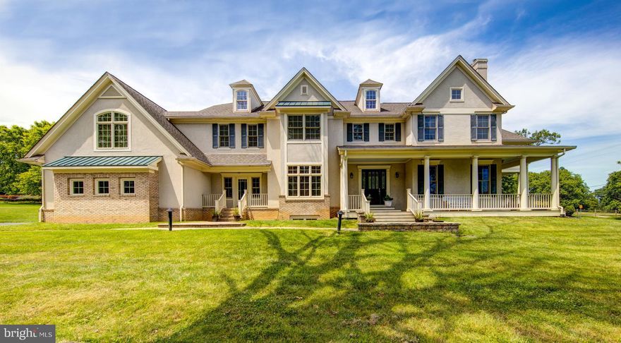 Gorgeous custom-built home in desirable Whitemarsh Valley Farms. Situated across the street from Whitemarsh Valley Country Club, this home has a pleasant, open layout with custom millwork throughout and an abundance of upgrades. Enjoy the views from your covered wrap-around front and side porches. There are multiple outdoor sitting areas, lovely gardens, mature trees and plantings, and a side patio with pergola and pillars. The exterior has tremendous charm with its mix of brick and stucco and the well-designed, architecturally appealing roof lines. Enter through your grand foyer with 10-foot-high coffered ceilings and beautiful, wrap-around, open staircase. To your right is your lovely formal living room with marble surround gas fireplace and wood mantel, coffered ceilings and a door that leads to your side porch. You also have access to your light-filled dining room through the large double doors. The dining room has quick and easy access to your kitchen through the butler's pantry, which also has a wine and beverage fridge. The entire back of the house is an open, yet warm and inviting living space composed of the large kitchen, eating area and living room. This space features multiple windows that let you enjoy the lush greenery, with multiple doors that allow easy access to the private back and side yards. Your kitchen has ample storage and a large pantry, granite tops, Dacor 5 burner gas cooking range, a Dacor double oven and warming drawer, Sub-Zero Fridge, under counter microwave, Bosch dishwasher, and wine refrigerator, making it a perfect place to entertain and bring your family and friends together. To the left of the kitchen is your family room with cathedral ceilings and a second gas fireplace with stone surround and built-in shelves. Easy access to your side patio and pergola off of the family room. To the left of the foyer is your prominent office space with built-in shelves. Behind the office is a large laundry room and mud room with entrance from the front porch. Don't miss the laundry shoot in the second-floor hallway! Huge, unfinished basement with full bathroom and outside access through the stairs to the garage. The second-floor master suite has 2 huge walk-in closets, vaulted ceiling, master bath with double sinks and soaking tub, and separate shower enclosure. On the second level there are 3 additional bedrooms, 2 full-baths and a bonus room to be used as the 5th bedroom, additional rec room, au pair suite or office. The bonus room above the garage also has a vaulted ceiling and back staircase that leads to the lower level. The princess room has a vaulted ceiling and private bath. Complete with a two-car oversized garage this home, is just waiting for you to move right in and enjoy your new home. Additional features include: surround sound throughout most of the home and outdoor patio, water softening system, Aprilaire Humidifier, Bradford White Hot Water Tank w/ warranty to 9/2026; two zone Lennox heating/air system (one system under warranty) custom cherry wood book shelves in office, custom built in entertainment center, Ipe wood porch, plantation shutters in Master Bath, Pella windows and Doors. In addition to the back yard space there are two large side yards which could be fenced in. Walk to the entrance of the Wissahickon Trails and just a short drive to Chestnut Hill and Ft. Washington State Park.