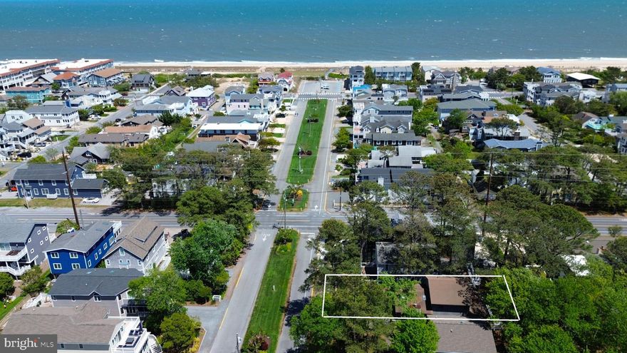 Just one block from the beach, this coastal retreat offers an easy walk to the ocean, as well as downtown Bethany’s shops, restaurants, and boardwalk. This 4-bedroom, 3.5-bath home features a spacious great room with soaring ceilings, abundant windows, and plenty of natural light. The kitchen offers crisp white cabinetry, a subway tile backsplash, granite countertops, stainless steel appliances, and a large island, all opening seamlessly to the living and dining areas. Step outside to the screened porch and sun deck, creating the perfect setting for relaxing or entertaining after a day at the beach. The main level includes two primary bedrooms, each with new carpeting and an ensuite bathroom, plus a convenient half bath for guests, while the upper level offers two generously sized guest bedrooms and an additional full bath. The ground level features an outdoor shower, storage space for beach chairs, and covered parking with additional storage for bikes. Offered fully furnished, this home is ready to enjoy as your own beach retreat or investment opportunity.  Ideally situated on one of Bethany Beach’s most sought-after streets, leave your car parked and enjoy the best of coastal living just steps from the sand and surf.