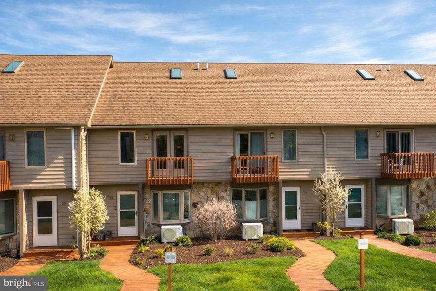 Just an incredible location for this townhouse located in a waterfront community and directly across the street from the Wisp Resort. Featuring 4 levels of living area, this townhouse has been updated kitchen and baths. Relax in the hot tub located on the patio of the lower level. Deep Creek Village has 12 dock slips for 48 homeowners. Lower level can be used as bedroom with full bath or use it as a family room. Main level features updated kitchen, living room with gas fireplace. Upper level features two bedroom and two full baths with one being a primary bedroom with primary bath. Upper level is a loft with built in bunks with sleeping for four. Good views of the lake and great views of the Wisp. Community amenities include docks, kayak racks, and tennis/pickleball courts.