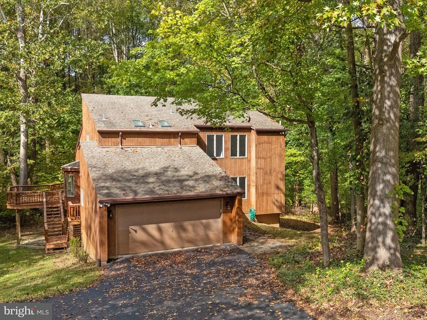 BY NO FAULT OF THE SELLER THIS BEAUTIFUL HOME IS BACK ON THE MARKET! Buyers loss is your gain. HUGE PRICE IMPROVEMENT! Welcome to 812 Richardson Drive, a serene country-style retreat nestled on 2.76 picturesque acres in sought-after Harwood. This charming freshly painted home offers the perfect blend of warmth, comfort, and privacy surrounded by nature. The main level welcomes you with spaces filled of natural light, skylights and features a fireplace for relaxing gatherings. A bright kitchen and dining area open to an upper sun deck, overlooking peaceful wooded views. The main level bedroom and full bath offer flexible living options, complimented by a convenient half-bath off the laundry/mudroom. Upstairs, along the walkway overlooking the main level, you will find three spacious bedrooms with all new carpeting, including a lovely primary suite with its own full bath and tranquil views. An additional full bath completes the upper level. The finished basement, with two walkout sliding doors, offers ample space for recreation, hobbies, or a home office. A large utility room and separate room under the steps, provide generous storage. Set on a quiet cul de sac, this comfortable home includes an attached two-car garage and an additional parking pad, adding to everyday convenience. Come home to this beautiful, wooded property offering tranquility, privacy and plenty of room to enjoy indoor and outdoor living. Perfectly located in the heart of Harwood with no HOA, this rare find combines quiet charm with everyday functionality; an ideal setting for those seeking peace, space, and timeless Maryland countryside living, while still close to restaurants, shopping, waterways, and commuter routes.