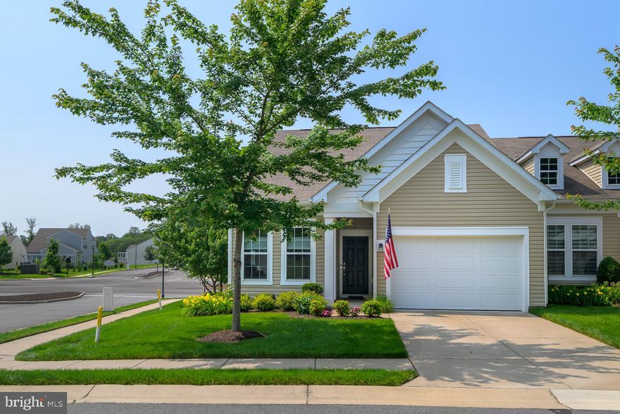 Price Adjustment. A new chapter of single-level, low maintenance living awaits! Available for the first time is this 2 Bedrooms (+ bonus NTC 3rd BR / Flex Room), 2 Full Bathrooms, 1,528 square feet of finished living space w/ attached garage Villa at 112 Long Point Drive in the Celebrate Virginia Active Adult 55+ Community. A 2018 Pulte Homes build, the original owner has stylishly maintained this turnkey Semi-Detached Ranch Home that enjoys tons of natural light from 3 exposures as an End Unit w/ 9-foot ceilings. The open concept layout centers around a gourmet Kitchen featuring a massive wet island w/ bar seating and under cabinets for extra storage and hidden trash/recycling, Whirlpool stainless steel appliances (including a filtered fridge water dispenser and ice maker), a chef-inspired gas cooktop and professional range hood, built-in microwave and wall oven, and a neutral ceramic-tiled backsplash. Espresso solid wood 42" cabinets w/ under cabinet lighting and Toasted Almond Quartz countertops bring a refined elegance to the space. A large, walk-in pantry bisects the custom cabinetry to ensure plenty of room for small appliances and food storage. The main living area + Flex Room features durable, engineered 5" plank hand scraped dark hardwoods throughout. The Primary Bedroom faces the backyard green space and features plush wall-to-wall carpeting, a large Walk-In closet + an ensuite Primary Bathroom w/ a custom-tiled walk-in shower (w/ bench) and double sink vanity. The 2nd Bedroom contains plush wall-to-wall carpeting and is situated on the frontside of the home with easy access to the 2nd Bathroom. Both the Primary Bathroom and 2nd Bathroom feature Espresso solid wood vanity cabinets and Toasted Almond Quartz countertops. Rounding out the rooms is a bonus Flex Room enclosed through glass-paneled French doors that is perfect for a home office, lounge, craft room or NTC 3rd Bedroom. Completing the floor plan is an open "Mud Room" w/ coat closet and entry from the garage and a separate Laundry Room w/ Washer and Dryer that convey. LED recessed lighting and custom "up/down" window shades add versatility for light variance and privacy. This "Bluemont" model floor plan is loaded with optional upgrades including a Lot premium for the desirable location within the Community, exterior elevation design premium, a gas fireplace w/ mantel and granite hearth in the Living Room, and 4 ceiling fans (in both Bedrooms, Living Room and Flex Room).

A wall of windows and glass slider leads to an outdoor custom paver back patio overlooking a lush green space (all lawn maintenance covered and handled by HOA). The garage has a self-contained workshop and opens out to a concrete paved driveway that provides off-street parking for a 2nd car adjacent to the private front yard. Additional guest parking is immediately across the street for guests. A multi-zone irrigation sprinkler system keeps the front and rear yard green year round! 

Sited within an active lifestyle community cluster of residences, amenities include sport courts (pickleball, tennis and bocce), indoor / outdoor pool, putting green and the Riverside Lodge complete with a fitness center and indoor walking track. Celebrate by Virginia includes social clubs, event spaces, and regular community gatherings! Snow removal included in the HOA fee. 5 minutes from Celebrate Virginia North Shopping Center, 10 mins to I-95 access (Route 17) and 15 mins to Downtown Fredericksburg. Welcome home!