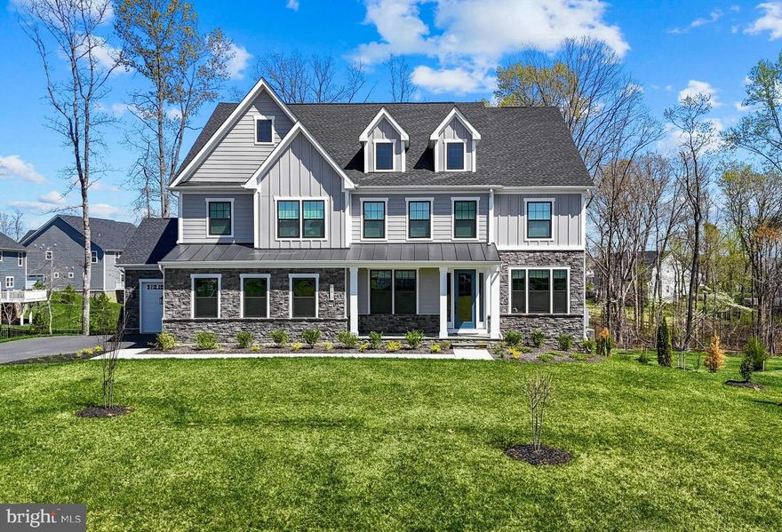 Spectacular Dream Home in one of the most prestigious addresses in the Fredericksburg area. Located within the gates of Fawn Lake, this ​sophisticated, beautifully appointed turn-key residence, featuring a ​modern, elegant and flowing interior with upgraded finishes was designed for both luxurious daily living and impressive entertaining. Exquisite finishes such as 10 FT ceilings, tall windows, custom tile, and wide plank wood floors elevate the ​voluminous spaces throughout this gorgeous home.
The impressive facade with stacked stone and black-framed windows combined with board and batten siding​, create a modern aesthetic that leaves a lasting impression. The welcoming flagstone front porch leads to an inviting Foyer, which is anchored by a Formal Living Room that can serve as an optional Study, and a fabulous Dining Room with an ​incredible Butlers Pantry​ right  around the corner. 
A spectacular Great Room with a soaring two-story coffered ceiling​ with an amazing chandelier, and a dramatic wall of windows overlooking the wooded back yard, opens to the amazing Chef's Gourmet Kitchen with an abundance of upgraded Cabinetry and Quartz countertops, a massive center island, tile backsplash, ​upgraded stainless steel appliances and a large walk-in pantry. 

​A gracious main level Bedroom with a beautiful private bath and walk-in closet is perfect for guests.  
A large Mud Room with a convenient drop zone completes the main floor.

The​ wide staircase leads to the upper level ​bedrooms. A perfect sanctuary, the fabulous Owner's Suite with ​sitting area, features a luxury Spa Bath with tile shower and double vanities, plus an amazing walk-in closet! 
T​hree Generous ​en-suite Bedrooms with Full Baths and walk-in closets​ offer ample space for the whole family. ​The large laundry room with a utility sink is conveniently located on the upper level. A ​long balcony overloo​ks the luxurious space below.

The finished walk-out basement continues to impress. Designed with abundant comforts and features to entertain, it features a ​huge Recreation Room​, lounge, Gym, Full Bath, and ​an amazing Bar with beverage fridge, sink and dishwasher.
The covered porch, overlooking the backyard which abuts to a wooded conservation area, is perfect for extended outdoor living, alfresco dining, and entertaining!

The grounds are easily maintained with the in ground irrigation system.  Complete with an oversized 3-Car Garage!  Located within walking distance to the Fawn Lake Marina!
You will live with ease in this luxuriously beautifully designed turn-key dream home built in June 2024!
 Don't miss this incredible opportunity to own a newer Home in one of the most prestigious addresses in the Fredericksburg area!

The beautiful Luxury Fawn Lake Community offers amazing amenities such as a boating recreational lake, beach, Arnold Palmer designed golf course, tennis courts, baseball and soccer fields, dog park, volleyball courts, walking trails, Community ClubHouse, marina, fitness center, restaurants, Country Club, playgrounds, and so much more! Located in the countryside near the town of Fredericksburg, surrounded by park lands and only a few miles to the farm market, wineries, and award winning breweries!