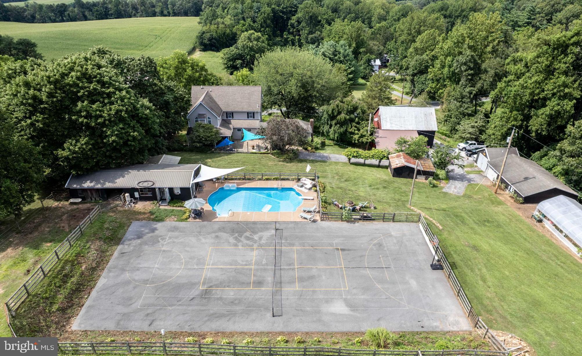 OPEN HOUSE Saturday September 20th 1-3PM*True opportunity to own your 5BR 3.5Baths dream farmette with income producing micro greens business, modern home updates, & an entertainer's delight with in ground pool, sport court, barn, detached garages, & in law accessory dwelling*Also suited for multi-generational living*The main home remodeled in 2001 boasts foyer, updated half bath, mud room, cozy living room, open concept family room with gas fireplace that flows to the updated huge kitchen with upgraded counter tops & island*Formal Dining room for special occasions*Upper level has an recently remodeled primary suite with vaulted ceilings, custom stone work decorative fireplace, a primary bathroom with luxurious tiled walk in shower/double sinks remodeled in 2024, another full bath, & 3 other bedrooms all with wide plank luxury vinyl flooring*Lower level is ideal for storage & houses the geothermal system which saves thousands on your utility bills*3 zones of HVAC help with additional efficiencies*Connected through a breezeway across the paver patio is a bonus room that could function as yet another bedroom or office space*An additional special feature is the newly renovated in-law apartment attached to the barn complete with open concept kitchenette, living room, bedroom, & another updated full bathroom*Once outside, enjoy true "resort type" living with a beautiful paver patio, covered front & rear porches, a large in-ground pool with adjacent pool house, & a full size sport/tennis court*Above this is field space for your animals or farming needs*Sellers own the expansive solar units which help offset the microgreens business energy needs*This area is also fenced as it is currently home to 2 donkeys*In the past, sellers have planted crops and wild flowers on the hillside*The opportunity to take over the established microgreen business on site is also negotiable*Seller can give more details upon request*
HOME BUSINESS INFORMATION: Located in Hampstead, Maryland, "Five Cedars Farm" has been providing Hydroponic Bibb Lettuce and Microgreens to Baltimore/York/Gettysburg Restaurants and Groceries since 2018. With Sales approaching $100K, this home-based business has a 55% profit margin. Produce is grown indoors, year-round, for the most consistent premium product of any farm in the area. Five Cedars Farm is operated by a Husband and Wife Team and one part time employee. Nine varieties of Microgreens are grown indoors in a climate-controlled environment. Greens are cut to order 4 days a week and delivered within 4 hours for the freshest, longest lasting microgreens in the market. Chefs recognize the superior quality and flavor and value of FCF microgreens. Hydroponic Lettuce is grown in a fully automated self-contained, purpose-built greenhouse. Approximately 400 heads of lettuce are planted, harvested and sold weekly to restaurants and grocery stores. Lettuce has a 7-week growth cycle.