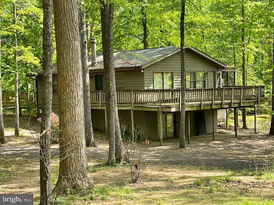 Attention investors! Fantastic potential lies within 203 Happy Creek in amenity-rich Lake of the Woods, being sold as-is! It offers a prime location on an amazing corner lot within walking distance of a beach! A private, gated, secured community, Lake of the Woods offers anything and everything you could possibly want. Home to two lakes (the 550 acre main lake and a 35 acre "fishing lake"), a golf course, an equestrian center, a fire and rescue department, and a church all within the gates, Lake of the Woods simply has it all. Whether your passion is boating, water skiing, kayaking, golfing, horseback riding, or simply taking in the breathtaking views from the clubhouse while enjoying a fabulous meal, from your own deck or yard, or from one of the beaches, you won't be disappointed! Perhaps you'd like a game of bridge or volunteering your time and talents...Lake of the Woods offers more than 60 clubs and/or organizations from which you may choose to become involved. Located in Orange County, we are fortunate to enjoy low real estate taxes. Coupled with home prices ranging from the upper-$100,000s to over $2,000,000, Lake of the Woods is the perfect community for both full-time residents, as well as weekenders. But don't take my word for it, please come see for yourself! I will gladly give you a tour of Lake of the Woods by boat and by car so that you may experience why I love Lake of the Woods!