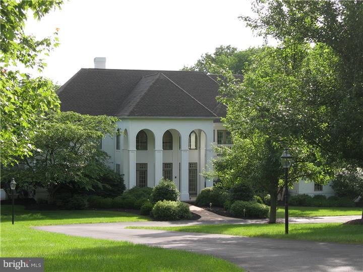 This Magnificent custom home is situated on a private drive in prestigious Solebury Township, nestled among a select enclave of highly desirable and beautiful custom homes built by well respected custom builder, Richard Zaveta. This 5 Br, 4 BA and 3 FP majestic home sits on 3.85 acres of natural beauty and privacy. Enter the grand foyer and admire the magnificent 2 story living room with wall of windows that leads you to an exquisite terrace overlooking a beautiful swimming pool with lush, specimen plantings and landscaping. Admire the extraordinary craftsmanship and attention to detail that resonates throughout this gracious residence. Be impressed with the spaciousness of the designer kitchen with morning room and butler's pantry. Featuring all custom interior finishing, this home is cloaked in handsome cherry wood, bathed in natural sunlight from tall and oversized windows and adorned by intricately designed ceilings, custom millwork and built-in cabinetry. The luxurious master bath was just renovated (2014) and additional enhancements have recently been completed. The finished lower level with ground floor elevation was designed with entertaining in mind with indoor and outdoor entertainment areas and atrium doors that lead to a covered patio and luxurious in ground swimming pool. A recreational room, exercise room, 5th bedroom and full bath complete the lower level.