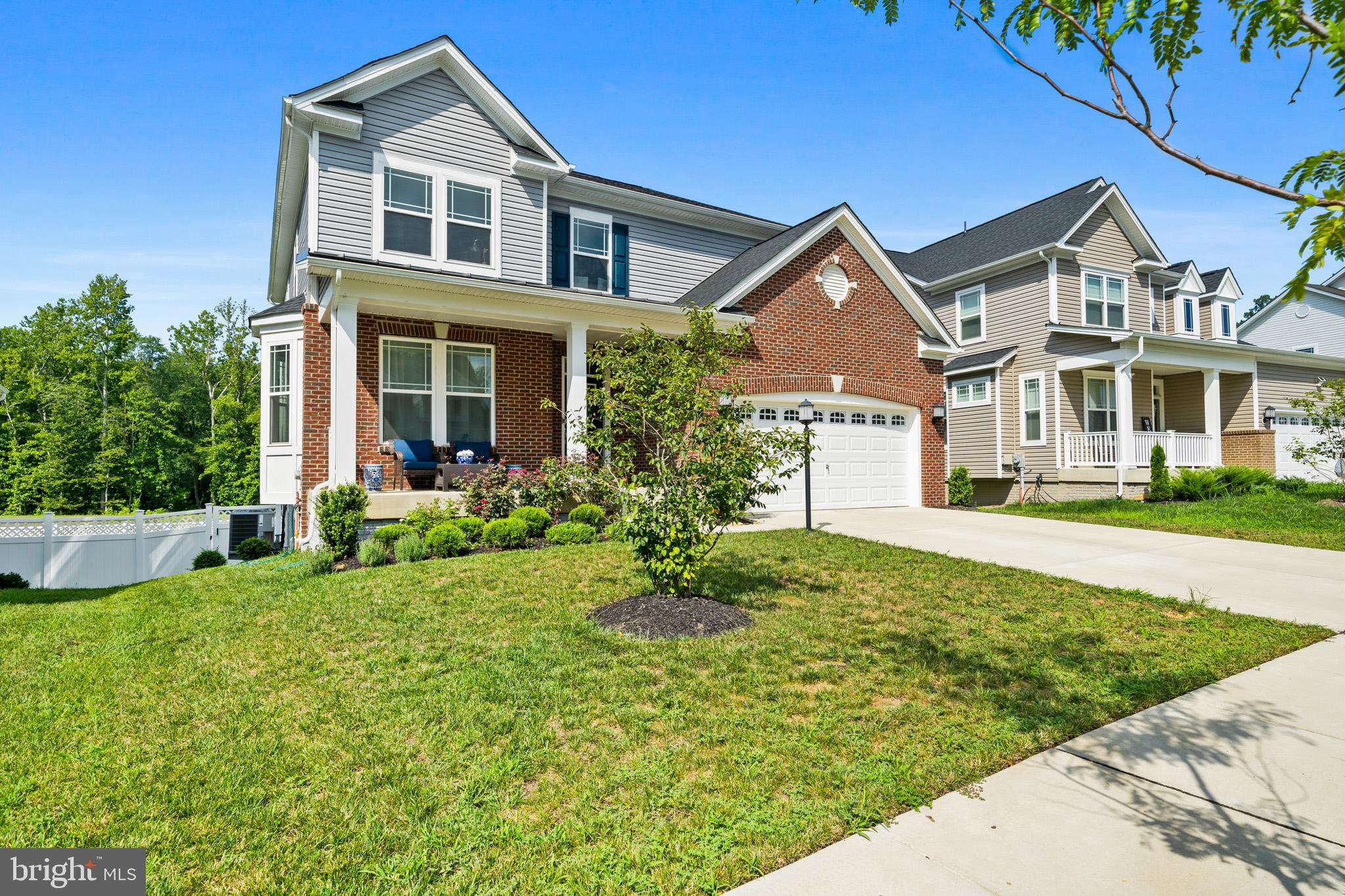 WELCOME HOME to this stunning over 4000 sq ft brick colonial just built in 2023!!! Meticulously maintained with a main level bedroom AND a full in-law suite in the finished basement... this home offers the perfect blend of modern style and comfortable living! Soak in the cozy front porch and then make your way inside to an inviting foyer/entryway with LVP flooring, 9 ft' ceilings, crown molding, and a formal living room off the foyer with a bay window, double crown molding, and recessed lighting. The spacious kitchen boasts 42' cabinetry, TONS of counter space (including a large kitchen island), backsplash, stainless steel appliances, gas stove, and granite counters. The kitchen flows seamlessly into the dining area and family room with a gas fireplace—perfect for everyday life and entertaining. Off family room is a convenient main level bedroom and a full bathroom. Upstairs, you’ll find a bright and airy primary suite with tray ceilings, a sitting area, 2 walk-in closets and private bath with double sinks, soaking tub, and a separate shower. Upstairs includes 3 additional nicely sized bedrooms, a full hallway bathroom, and the laundry room. The fully finished lower level is a standout feature, offering a huge rec room that can be transformed into a home theater, gym, or game room—whatever fits your lifestyle best! The lower level also includes a full apartment/in-law suite with a kitchenette, 2 bedrooms, and a full bathroom. Don't miss your chance to own this immaculate, move-in ready home in a sought-after community in a convenient location to shops, dining, schools, commuter routes and more —schedule your private showing today!