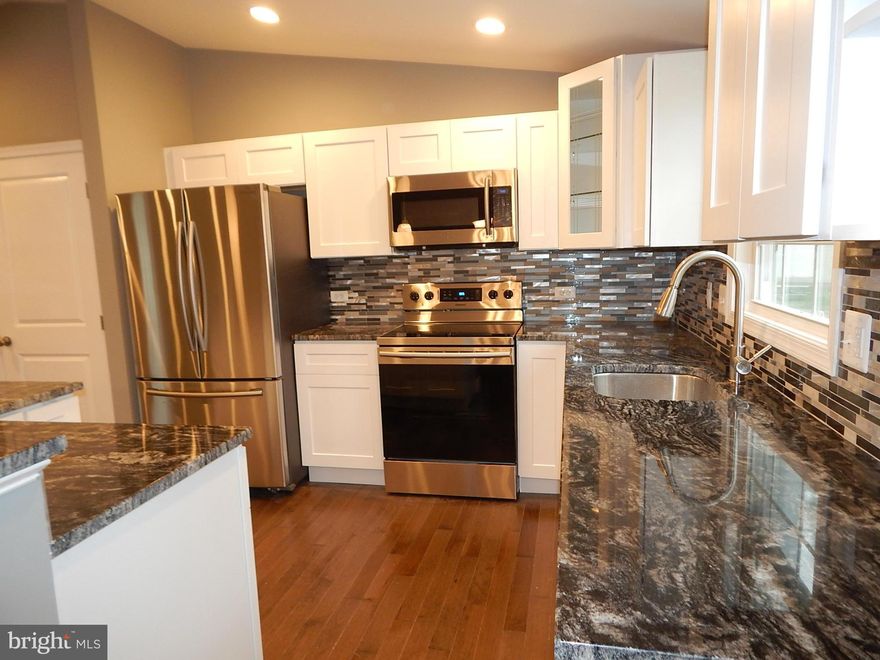 Beautifully rehabbed 4 level split in cul-de-sac. Fabulous kitchen w new cabinets, center island, granite counters and stainless steel appliances. New maple hardwood floors. 3 new full ceramic bathrooms. Inverted tray ceilings, recessed lights, large family room w granite wet bar and screened in porch. Chair rail & recessed LED lights. Short walk to community pools, tennis courts & walking trails.