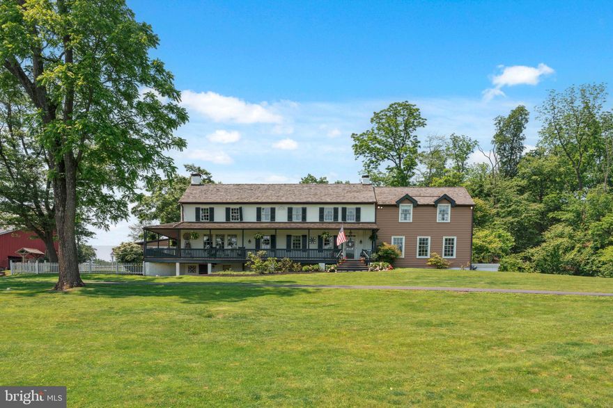 Welcome to an extraordinary retreat where historic charm meets refined living. Tucked away on over 39 acres of rolling meadows and woodlands, this impeccably restored 1700s farmhouse blends rich heritage with thoughtful modern updates, offering a lifestyle that is both peaceful and inspiring.

As you enter through a private, winding driveway, a professionally engineered bridge gracefully carries you over a scenic pond, fully stocked with bass and catfish, toward the heart of the estate. Cast a line, launch a kayak, or simply unwind on the dock while soaking in the idyllic views that surround you.

Inside, the home has been masterfully renovated to honor its original character while introducing high-end comforts. Wide-plank pine floors, exposed wood beams, and detailed crown moldings echo its historic roots, while radiant heated floors and updated mechanical systems provide today’s conveniences.

The gourmet kitchen strikes a stunning balance between rustic elegance and function with stainless steel appliances, Corian countertops, custom cabinetry, and a walk-in hearth fireplace reminiscent of centuries past. A light-filled breakfast room and adjacent sunroom overlook the pond, creating the perfect morning escape. Nearby, the formal dining room, with its fireplace and wall of windows, flows seamlessly into a cozy den and an expansive family room complete with wood-beamed ceilings, a bar, and yet another fireplace.

A character-rich mudroom, adorned with brick floors and timber accents, connects to a charming powder room and exposed ceiling beams, a labor of love by the current owners. A thoughtfully designed three-story addition adds incredible flexibility: on the main floor, a sun-drenched office with French doors opens to a private deck; downstairs, a walkout basement offers finished living space alongside original stone storage rooms and upgraded mechanicals including dual water heaters, 400-amp electric, 5-zone A/C, 6-zone heating, and full-house natural gas generator backup.

Upstairs, four well-appointed bedrooms await. The primary suite is a peaceful sanctuary featuring its own fireplace, generous closets, a luxurious ensuite with double vanity, glass shower, jetted soaking tub, and French doors that open to a Juliet balcony overlooking the picturesque grounds. Three additional bedrooms share a beautifully updated hall bathroom with double vanity.

The property has been impeccably maintained with major investments, including a full roof replacement in 2022 featuring cedar shake shingles, standing seam copper accents, and new Pella windows and doors throughout.

Step outside to enjoy every inch of the estate: a wrap-around covered porch with tranquil views, a newly renovated in-ground pool with surrounding deck, and a charming cabana outfitted with a summer kitchen, powder room, and changing area. Entertain effortlessly with built-in brick grill ovens and an inviting space to gather poolside.

Equestrians and hobbyists alike will love the 8-stall barn, fully rewired and beautifully maintained, alongside two additional outbuildings. One is a 40' x 60' insulated and heated Quonset hut, currently housing a classic car collection. All outbuildings, including the barn and cabana, have new standing seam metal roofs, cypress siding, and handsome cupolas, continuing the estate’s cohesive aesthetic.

The land itself is a natural wonder, featuring a professionally dredged pond with a new dam, winding trails for riding or hiking, and a fenced pasture for livestock. To the right of the home lies 50 acres of preserved land, offering perpetual privacy and an untouched view.

This estate is a one-of-a-kind opportunity for those seeking refined country living with historic soul, luxurious amenities, and unmatched tranquility, all just a short drive from major routes and city conveniences.