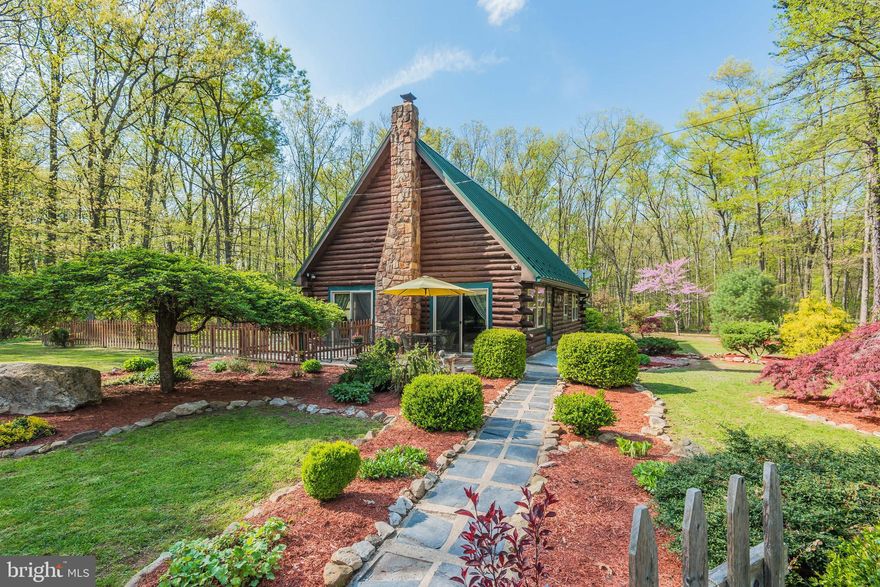 This log home is unique and located in a peaceful place. The landscaping has been thoughtfully tended to accentuate the forested setting at the base of the South Mountain. The property sits close by two beautiful streams to the front and rear of the home. The master bedroom is in the loft of the home, overlooking the living area on the main level.  There is another large living room beyond the kitchen and dining area. The property has a detached 2-car garage with upper level storage area. Schedule your exclusive tour of this special property!