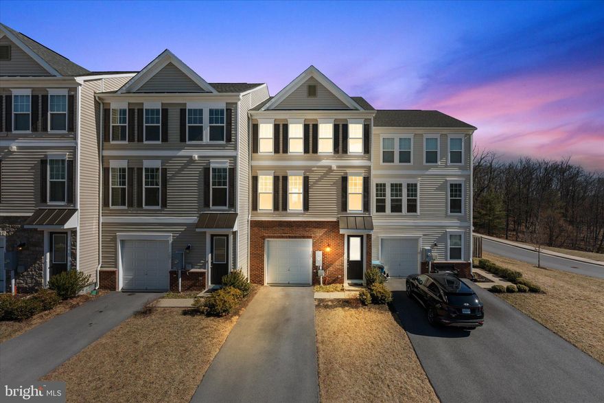 Back on the Market! Buyer's Financing Did Not Work Out! Welcome to this beautiful 3-bedroom, 3.5-bathroom townhome, built in 2019, offering modern comfort and convenience. Nestled in a tranquil setting, the home backs to serene woods, providing privacy and a peaceful atmosphere. The well-maintained interior features brand new carpeting in the basement and a walkout to the backyard, perfect for outdoor enjoyment. With a spacious driveway that accommodates two cars and ample visitor parking nearby, convenience is at your doorstep. The private deck feels like an extension of the surrounding nature, offering a perfect retreat. Inside, the open-concept main level includes a cozy electric fireplace and a convenient half bathroom. The master bedroom is a standout with its beautiful tray ceiling, adding elegance to the space. The garage provides excellent shelving for extra storage, ensuring everything has its place. The neighborhood is full of amenities including two tot lots, tennis courts, and a gazebo, along with walking paths and dog waste stations for added convenience. Plus, a lovely walking trail behind the neighborhood leads around a large lake, perfect for fishing, with a full loop of about 2 miles. Enjoy the benefits of a home just 6 years young without the new construction price tag!