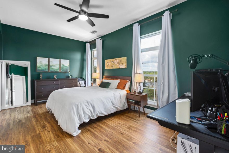 Imagine waking up and looking out onto scenic Occoquan river views while sipping your morning coffee or tea. Waterfront facing with the highest view, this corner unit feels lofty and sun-filled. A huge bonus, there is nobody living above you. With two spacious primary suites, you have ample room for guests to stay with you. The open concept kitchen, dining, and family room is great for entertaining and being present while cooking a delicious meal. Multiple large windows let in sunlight and stunning views. Enjoy the balcony or the rooftop for amazing views of the river, grilling while enjoying drinks, or watching an epic Fourth of July firework display. Convenience is close by, with grocery stores, Potomac Mills, Stonebridge, and Old Town Occoquan in the vicinity. There is a VRE station within walking distance, for commuting into the city. I95 and Rt1 is a close jaunt to hop on. Surprising for how conveniently located it is, this place is truly a peaceful oasis, a gem to be found in busy Woodbridge, where you feel you’ve been transplanted somewhere more quiet and nature-filled, yet requiring no outdoor maintenance with condo living. There are so many amenities in Belmont Bay: walking trails, a marina, pool, tennis courts, organized events, and more. With this unit, you get one assigned parking spot in the secure parking garage, and one unassigned outdoor parking spot. A new HVAC unit was installed in 2022, as well as new LVP flooring with sound dampening in one of the primary rooms in 2023. The washer and dryer convey and are located within the unit. Make this condo your own, and enjoy convenience with peaceful living.