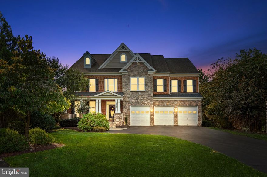 Welcome to 22197 Withers Grove Court, an exceptional stone-front Colonial situated on one of the largest lots in Broadlands. This spacious residence offers approximately 6,750 square feet of finished living space, featuring seven bedrooms, six and a half bathrooms, and a three-car front-load garage with an extended driveway.

The main level features an inviting two-story foyer, formal living and dining rooms, and a private office that can also serve as a main-level bedroom with its own full bath—ideal for guests or multi-generational living. The open-concept kitchen showcases remodeled cabinetry, upgraded KitchenAid appliances, a large center island, and abundant storage, flowing seamlessly into the sun-filled family room and adjacent sunroom where you can enjoy serene views of the trees and stunning evening sunsets.

Upstairs, the primary suite impresses with a completely renovated marble bathroom, dual vanities, soaking tub, frameless glass shower, and custom his-and-her walk-in closets offering generous built-in storage. Additional bedrooms include an ensuite with a renovated bath, along with spacious secondary bedrooms offering ample closet space and access to well-appointed bathrooms.

The finished walk-out lower level provides exceptional versatility with a spacious recreation room, a mini kitchen, a full bedroom and bath, a dedicated gym, and an additional room ideal for a media or hobby space. The basement opens to a beautifully designed patio—perfect for relaxing or entertaining.

Outdoor living is equally impressive, featuring a large deck overlooking the expansive .70-acre lot—one of the largest in the community—with plenty of space for gatherings, play, and gardening.

Additional highlights include replaced roof and siding, replaced HVAC systems for both zones, a humidifier, irrigation system, exterior lighting package, and custom built-ins in select areas.

This Broadlands residence offers space, flexibility, and thoughtful updates in a sought-after community, close to shopping, dining, and major commuter routes.