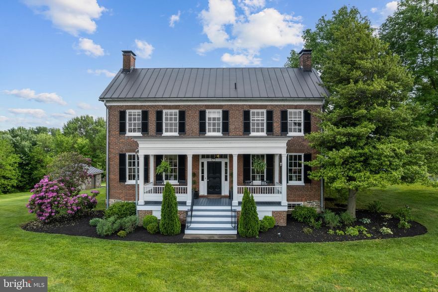 Fall in love with this one-of-a-kind, fully renovated historic farmhouse in the Wright Farm community in Purcellville. Featured in “Country Home Magazine,” you feel like you are walking through a magazine.  The original two-story brick farmhouse was built in 1853, the addition was constructed in 1910 and 1980, and the home's interior was modernized and beautifully decorated over the past five years, enhancing its overall charm. Recent updates include re-glazing all windows, replacing glass panels, painting the exterior, and re-coating the entire standing seam metal roof. This lovely home is on three lush acres of rolling lawns and mature trees. Inside, you will find five generously sized bedrooms, one loft/bedroom, four and a half baths, and  8000 square feet of living space, providing ample room for family and guests. Eight wood-burning fireplaces add to its historic charm and cozy ambiance. The main level is bright and sunny, featuring a fully renovated kitchen with custom cabinets, quartzite countertops, new stainless steel appliances, a big central island, a coffee bar with reclaimed wood shelves, a pantry, and 100+-year-old wood ceiling beams. The kitchen flows directly into the "hearth room," making it the perfect space for family gatherings. There are many places to gather, and the main level also features a beautiful dining room, living room, and cozy family room - all tied together by the sunlit breezeway.  A unique, possibly one-of-a-kind feature of the main level is the office/library with floor-to-ceiling built-in wood shelving and a rolling library ladder. It has to be seen in person to appreciate it truly. The spacious main-floor laundry is next to the back entrance and across from the built-in mudroom. There is also a well-decorated half bath close to the back door. Three staircases allow you to reach the upper level, with five oversized bedrooms, three full bathrooms, and a spacious loft/bedroom. The upper level has been renovated recently, including new carpet, window treatments, paint, wallpaper, and updated light fixtures; the layout is unique and charming as it has "His and Hers" primary bedrooms. The stunning spa-like primary bathroom was just renovated with marble floors, a marble tiled shower, a stand-alone tub, and two vanities with Carrara marble countertops and connects the primary bedrooms each with their own fireplace. You will also find two additional large walk-in closets. The remaining three bedrooms are large, and each has individual designer touches. The loft area is perfect for game night or teenager "hang out" space; it can also function as a sixth bedroom. The two additional full bathrooms have also been renovated/refreshed and are charming and highly functional. The lower level is a walk-out basement with a giant recreation room and a fourth full bath.  As you venture outside, you will fall in love with the wrap-around veranda and the massive stone patio - it is the perfect place to enjoy your morning coffee or a glass of wine in the evening while you admire the lovely landscaping on your three acres. The well-maintained crib barn with loft functions as a 2-car garage with lots of room for storage. This home was the first house in the Wright Farm Community but is independent of the HOA, which gives you lots of flexibility. Verizon FIOS is available for this home. Make this incredible, magazine-worthy home yours today!