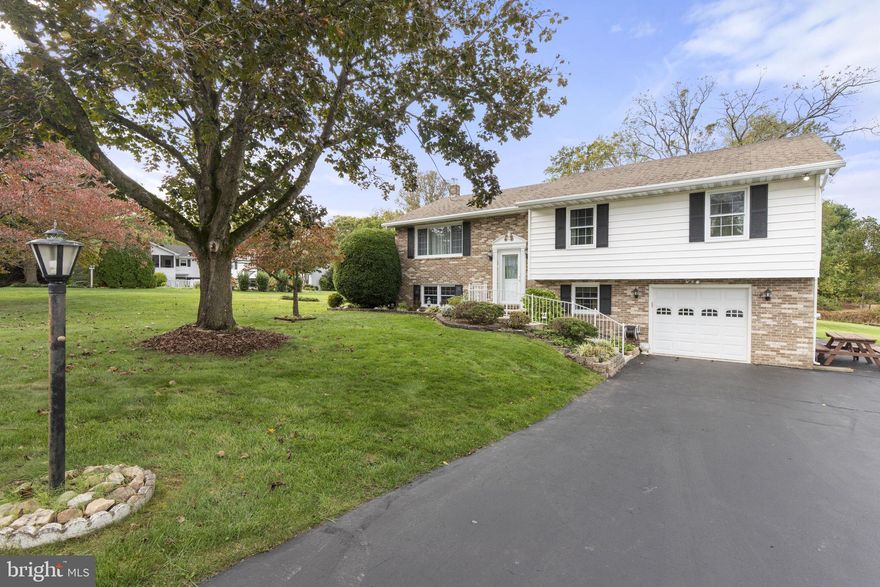 This custom-built 3-bedroom, 2-bath split foyer is set in the quiet Park Campus neighborhood of Churchville and has been meticulously maintained in pristine condition. The main level offers a light-filled living room with a large picture window, a dining room, and a spacious kitchen with sliders leading to a fully screened, covered deck—perfect for enjoying the peaceful setting. Three bedrooms and a full bath with Italian tile flooring complete this level. The finished lower level expands the living space with a large family room featuring sliders to a covered patio, plus a chimney opening for a wood stove or fireplace. A mudroom off the garage, a full bath, and abundant storage provide convenience and functionality. The front-load garage includes a tool bench and shelving, with an adjacent asphalt parking pad and an extra-long driveway accommodating multiple vehicles. Outdoors, the property spans over half an acre of level ground with two storage sheds. Recent updates include newer windows and a two-year-old water heater.