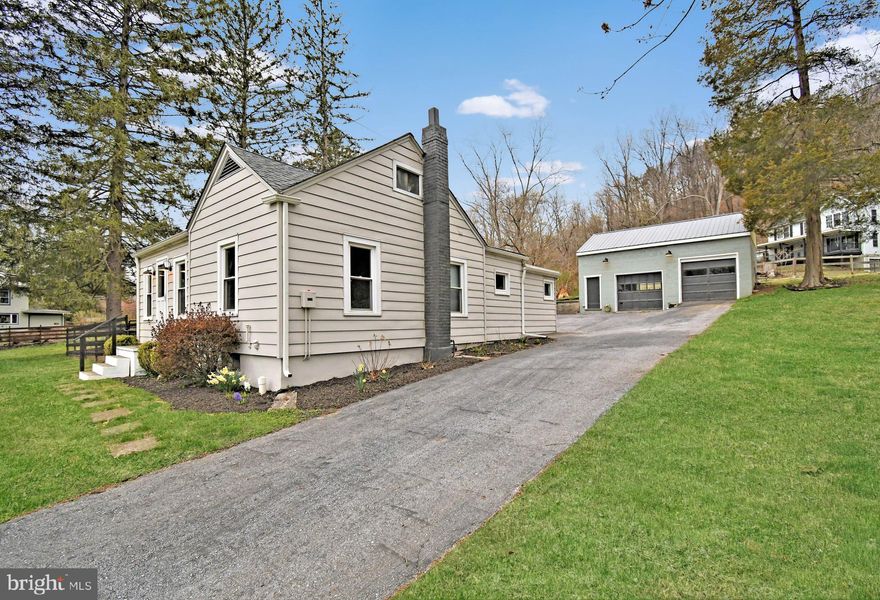 Welcome home to this storybook 2-bedroom rancher, perfectly set across the street from the tranquil waters of Manatawny Creek. From the moment you arrive, you’ll be swept away by the peaceful country setting and the warmth this home exudes. Inside, a sunlit living room welcomes you with gleaming hardwood floors and a striking stone wood-burning fireplace with a newer insert — a cozy centerpiece that fills the home with comfort. The heart of the home, the beautifully remodeled eat-in kitchen, features quartz countertops, custom cabinetry, stainless steel appliances with hood vent, a deep farmhouse sink, recessed lighting, a large pantry, and a built-in laundry space for easy first-floor living. The primary bedroom offers hardwood floors and shares a freshly updated full bath with the additional bedroom. Thoughtful extras include a spacious storage closet, pull-down attic access, and a hidden basement entry. Outside, a detached 2-car garage with electric and bonus finished space provides endless possibilities for a workshop, gym, or hobby room. Major updates include a newer roof and gutters (2019), a new grinder pump (2019), a new well pump (2016), New garage roof (2023), New electric wall heaters (2025), a  fenced yard, refinished hardwood floors(2025), and fresh interior paint — making this home truly move-in ready. Don’t miss your chance to own this slice of country paradise — schedule your private tour today!