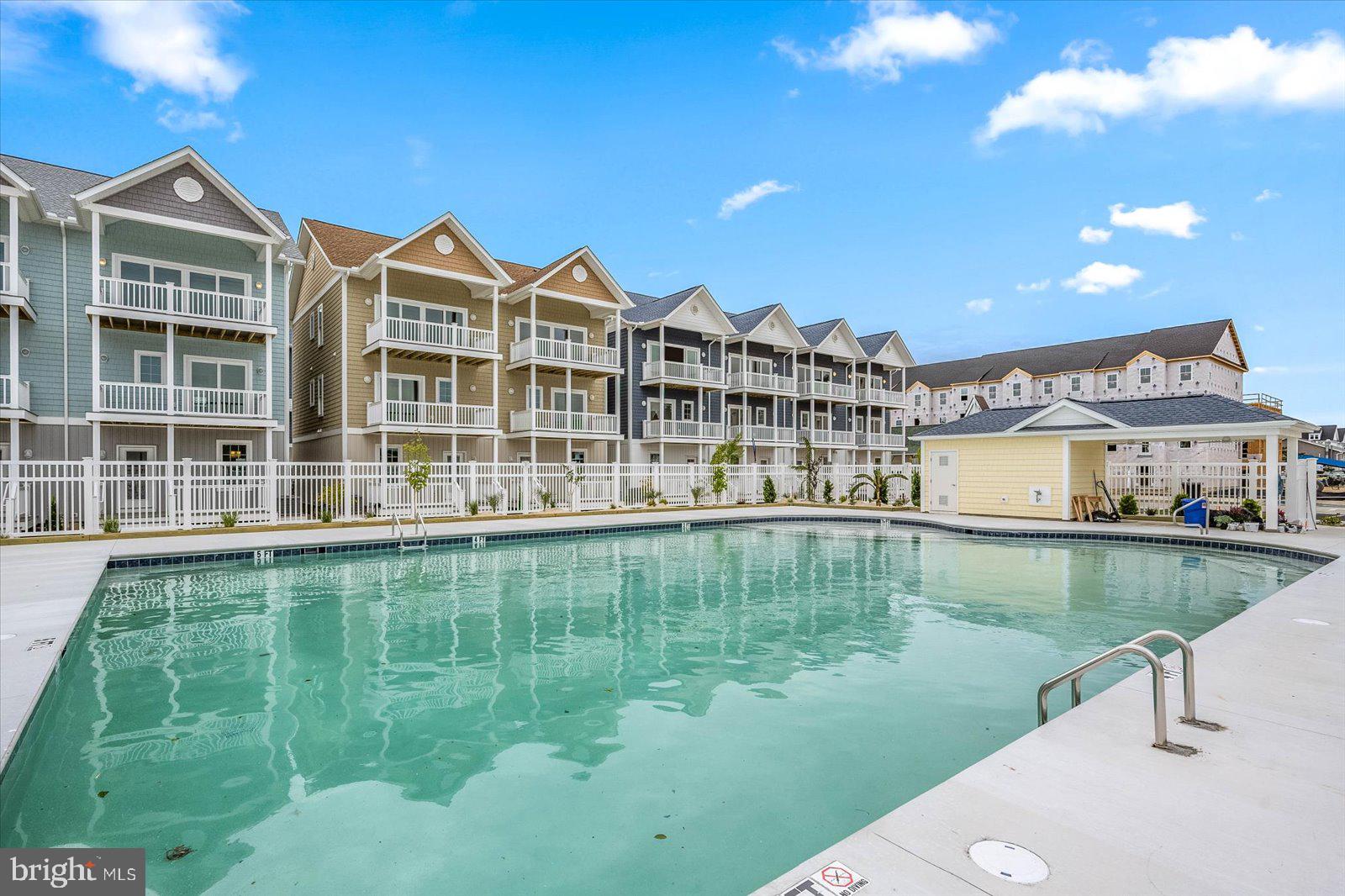 Newly Available Phase II @ Sanibel Seas NEW CONSTRUCTION! This Premiere Location Townhome is Eastern Townhome Quad with Beautiful Ocean Views! Enjoy your Large Deck on Every Level. You will appreciate the wood flooring in entry, stairs, halls, living, dining and kitchen, and quality lighting and fan fixtures throughout . Top Floor Living Space will STUN with vaulted ceilings and amazing space. Gourmet Kitchen with all Soft Closing White Coastal Cabinets including Pantry with drawers and under cabinet lighting, Wine Rack and Bin Storage, all GE Stainless Steel Appliances and Beautiful Quartz Countertops and Glass Tile Backsplash. Dining is off Kitchen and attached to Huge Living Space with Half Bath making it perfect for entertaining. Large Decks on Every Level too! The community boasts a 60' x 42' HEATED Outdoor Pool, Fenced Area with Lounge Chairs and Gazebo with Ceiling Fans and Shade. Located in Caine Woods Community with Green Space, Parks and Designated Bike Route for miles of enjoyment away from Coastal Hwy and direct path to Northside Park for all your Free Summer Fun. Don't forget to ask about our LOW CONDO FEES with NO surprise assessments. Find the PEACE of New Construction!