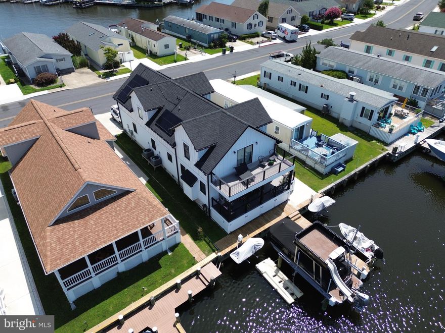 PLENTY of inside pictures coming by 8/18!!!! New Vinyl Bulkhead and New Jet Ski lifts and finger pier in 2021. Exceptional Custom-Built Waterfront Home in Montego Bay – 2,348 Sq Ft of Luxury on One of the Deepest Canals. Welcome to one of the most impressive custom homes in Ocean City’s desirable Montego Bay Community, where energy efficiency, thoughtful craftsmanship, and true waterfront living come together. Built in 2021, this exceptional 5-bedroom, 4.5-bath residence offers 2,348 square feet of beautifully designed living space with premium upgrades throughout — all perfectly situated on one of the deepest and widest canals in Montego Bay. Step inside and you’ll instantly feel the difference in quality and design. The heart of the home is the oversized gourmet kitchen, featuring solid surface countertops, generous cabinetry, and a large island with seating — perfect for gatherings, entertaining, or just enjoying a peaceful breakfast with views of the water. The main living and dining areas offer an inviting, open layout with plenty of natural light, water views from multiple angles, and access to the outdoor living spaces. Every inch of this home is tailored for comfort, functionality, and coastal charm. Upstairs, the private master suite is a true retreat — featuring its own private sundeck directly overlooking the water and a large walk-in closet, and a beautifully appointed en-suite bath. Imagine waking up to tranquil water views and stepping right outside to enjoy the breeze with your morning coffee.  With five generously sized bedrooms and 4.5 elegant bathrooms, this home offers flexibility for large families, guests, or even a home office. Each bathroom is finished with modern fixtures and tasteful design touches that elevate the home’s appeal. Designed with energy efficiency and peace of mind in mind, the home is equipped with: A full solar panel system for energy savings, Two-zone energy-efficient HVAC for year-round comfort, A full-home fire sprinkler system for added safety. A high-end security and camera system already in place, Outside, your waterfront lifestyle awaits. The property includes a private dock with room for relaxing, launching, or entertaining — and best of all, the sale of this home includes the pontoon boat and (2) jet skis, so you're ready to hit the water the moment you move in. 
Also featuring a covered first floor sundeck, well-maintained landscaping and plenty of parking and just steps to one of Montego Bay’s community swimming pools. Located around the corner from the 8-acre wildfowl lake, perfect for morning walks, jogs, or birdwatching. From the location to the layout, and from the amenities to the upgrades, this home was built to impress. Whether you're looking for a primary residence, vacation getaway, or income-producing property, this Montego Bay waterfront gem has it all.
This is a rare opportunity — schedule your private tour today and see what makes this custom home truly one-of-a-kind! HOA fee is $396.00 per year. Furnishings are Negotiable.