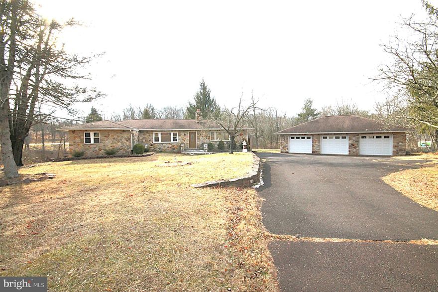 Here is your chance to own a 4-bedroom, 2 Bath stone front rancher, oversized 3 car Detached garage on almost 2 acres. Public water and sewer with an amazing lot backing to a small stream. As you enter, flanked to the right is a large Great room that houses your living rm and also dining area. The living rm includes a large built-in oak entertainment unit which will house your tv and other items of your choice. Plenty of sunlight in this area and includes recessed lighting, wood stove, ceiling fan, 2 closets and a door leading to a large 12’ x 40’ 2-tiered deck overlooking your beautiful yard. Next is your galley kitchen with oak cabinets, stainless steel appliances and an opening that will allow you to access your dinette area. The dinette includes a ceiling fan and sliding door that leads you back out to the deck. Up the hallway you find the hall bath and the four bedrooms. The fourth bedroom was used as an office/laundry rm and can easily be converted back to a bedroom. Heading down to the lower level you will see the second Bathroom, plenty of recessed lighting, 2nd laundry area, large brick wood burning fireplace and a door that provides you access to the unbelievable back yard that backs to a small stream. Walking back to the front of the house, you will see the huge 30’ x 40’ oversized 3 car garage with a walk-up attic for additional storage. You will also notice the expansive parking area for all of your guests. New Heater & AC unit in 2024, water heater in 2021. The location of this home is incredible, and you will not be disappointed so hurry and schedule your visit.