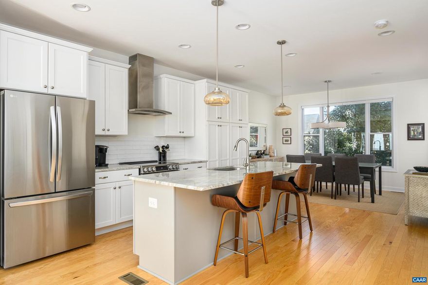 This beautiful, move-in ready 4 bedroom end-unit townhome is located within the desirable Belvedere neighborhood. Convenient access to the Rivanna River and just minutes away from public and private schools, great shopping and dining, downtown, and the University of Virginia.  Built in 2020, the 2,132 sqft townhome features a light-filled interior, spacious rooms, three finished living levels, Ting internet*, a large rear deck, and an attached rear-entry 2-car garage. Enjoy an array of community amenities, including multiple greenspaces, playscapes, and easy access to the SOCA Field House and the Center at Belvedere.  Step inside and discover hardwood floors that flow throughout an open-concept layout. The spacious kitchen features stainless steel appliances and granite countertops. Abundant natural light streams through large windows into the living room. Step out onto the expansive rear deck and soak in the mountain views.  Two additional bedrooms, a full bath, and a laundry area (washer/dryer included) complete this level. The ground level consists of the 4th bedroom that can also serve as a quiet home office, a full bath, and access to the garage.  One small full-grown dog (35lbs max) is allowed with fees. No cats.