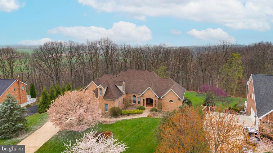 Rare opportunity to own one of the largest and finest brick ranch homes ever offered in Greencastle Greens Golf Course Community. Built in 2002, a local and renowned Toria Build, this one-owner, immaculately maintained home stands in a class of its own; and buyers who have been searching this community know exactly how seldom a home like this comes available.
With 3,854 square feet of finished living space above grade and an additional 4,067 square feet of open, walk-out lower level ready to be finished, the total usable footprint reaches 7,921 square feet on 1.66 private, wooded acres. 4 bedrooms, 3 full baths, 1 half bath, 3-car garage with epoxy floor finish and upgraded doors.
The quality of construction is evident from the moment you arrive: full brick exterior, concrete driveway, mature landscaping including Holly, Quickfire and Oak Leaf hydrangeas, Lilac, Crepe Myrtle, Nikko Deutzia, Boxwood, and Soft Serve evergreens framing the approach and flowering through three seasons. Inside: boasts 10-foot and cathedral ceilings, Brazilian cherry hardwood floors, granite countertops, Steve Hollenshead custom cherry cabinetry throughout, two propane fireplaces, Anderson windows, and a Therma-Tru front door. The open kitchen-to-living-room design captures wooded views from every angle.
The primary suite features a jetted tub, separate shower, elegant vanity, and two large walk-in closets, complete with custom organizers. An upper-level bedroom with private bath serves equally well as a studio, home office, or exercise room. The 500-sq-ft covered rear veranda; finished in stamped concrete with recessed lighting, T&G ceiling, and rear grill hookup also overlooks a private wooded backdrop. Dual Carrier heat pump systems, 5-zone climate control, electric backup heat, private well, and poured concrete walk-out lower level with French doors complete the picture. Greencastle-Antrim School District. I-81 corridor. Reach out today for your private showing!