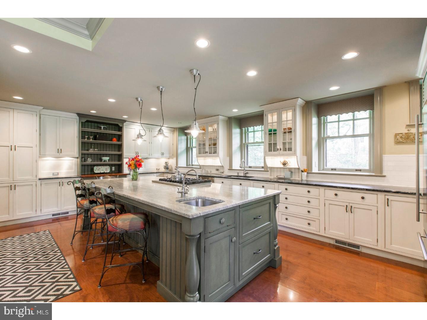 Experience the best of the Main Line in this gorgeous six bedroom, five and a half bath stone manor house on over one acre in Lower Merion Township. This lovingly maintained home combines the charm and style of its history with the modern amenities of today. The beautifully landscaped front yard welcomes your guests into the gracious vestibule entry. A grand parlor opens before you and leads to the light-filled, formal living room featuring hardwood floors, exposed wood beams, and a wood burning stone fireplace. Opposite the living room, the gleaming hardwood floors continue into the formal dining which is large enough for all of your guests and enjoys another fireplace, custom built-ins and window seats. The warm and cozy family room features stone walls, Saltillo tile floors, exposed beams and a stone fireplace. Both the living room and den have french doors that lead out to the enclosed sun porch. With an eye on every detail, the completely renovated kitchen features custom, two tone wood cabinetry, honed granite counter tops, surface lighting, a large center island with prep sink, gas cooking, a built in Sub Zero refrigerator and drawers, double ovens and more. The first floor also enjoys a powder room and functional mudroom with built in storage. Upstairs there are four bedrooms and three bathrooms. The master suite has a large walk in closet and private fireplace as well as a sleek en suite bath with a soaking tub, separate, glass shower stall and custom vanity. The conveniently located laundry area, as well as an office and a game room complete this level. The third floor features two more bedrooms, a full bath and walk in attic space for ample storage. The detached, three car garage provides an added bonus with a full apartment above. 10 minutes to Center City, close to the suburbs, and near the restaurants and shops of Bala Cynwyd. Also walking distance to the Cynwyd Heritage Trail and many places of worship, and all in the award winning Lower Merion School District.