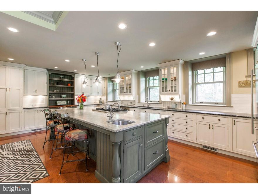 Experience the best of the Main Line in this gorgeous six bedroom, five and a half bath stone manor house on over one acre in Lower Merion Township.  This lovingly maintained home combines the charm and style of its history with the modern amenities of today.  The beautifully landscaped front yard welcomes your guests into the gracious vestibule entry.  A grand parlor opens before you and leads to the light-filled, formal living room featuring hardwood floors, exposed wood beams, and a wood burning stone fireplace.  Opposite the living room, the gleaming hardwood floors continue into the formal dining which is large enough for all of your guests and enjoys another fireplace, custom built-ins and window seats.  The warm and cozy family room features stone walls, Saltillo tile floors, exposed beams and a stone fireplace.  Both the living room and den have french doors that lead out to the enclosed sun porch.  With an eye on every detail, the completely renovated kitchen features custom, two tone wood cabinetry, honed granite counter tops, surface lighting, a large center island with prep sink, gas cooking, a built in Sub Zero refrigerator and drawers, double ovens and more.  The first floor also enjoys a powder room and functional mudroom with built in storage.  Upstairs there are four bedrooms and three bathrooms.  The master suite has a large walk in closet and private fireplace as well as a sleek en suite bath with a soaking tub, separate, glass shower stall and custom vanity.  The conveniently located laundry area, as well as an office and a game room complete this level.  The third floor features two more bedrooms, a full bath and walk in attic space for ample storage.  The detached, three car garage provides an added bonus with a full apartment above.  10 minutes to Center City, close to the suburbs, and near the restaurants and shops of Bala Cynwyd. Also walking distance to the Cynwyd Heritage Trail and many places of worship, and all in the award winning Lower Merion School District.