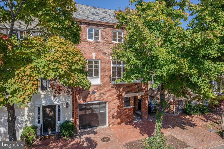 Thoughtfully re-imagined, updated for modern-day needs while retaining old-world charm: Dumbarton House is ready for its new owners to enjoy. This semi-detached, historic Georgetown brick home in the East Village, built in 1905, has been carefully renovated with meticulous attention to detail and the highest quality craftsmanship by Town & Country Builders with structural design by GTM Architects.  Julie Geyer Studio provided the masterful interior design and finish selections.

Enter through a grand foyer on the main level and prepare to be wowed by the quarter sawn white oak herringbone floors, bespoke stair rails, and other fine finishes. An attached one-car garage, a mud room, a guest suite, two living/family rooms, and ample outdoor space are just a few highlights. 

The main level of this home is an entertainer’s dream! The bright and sunny living room (with gas fireplace) offers fantastic indoor-outdoor flow with a wall of French Doors, creating an extended living space into the rear portion of the lot. The bluestone patio features a custom outdoor kitchen with Napoleon gas grill and Liebherr refrigerator. A tiered lawn area, composed of easy-maintenance, high-end astroturf grass, completes this fenced-in, private yard. 

The exquisite kitchen is equipped with Christiana Kitchen cabinets, La Corneau dual-fuel range and custom hood, Sub-Zero refrigerator, quartzite backsplash & countertops, and an expanded island with bar seating. The large, south-facing dining room is flooded with light through historic, re-glazed windows and boiserie paneling. Off the foyer you will find both a large coat closet and a striking powder room.

On the upper level, the primary suite includes a coffered ceiling, a custom walk-in closet by California Closets, and an ensuite bath with large marble shower and dual-sink vanity. The additional bedrooms enjoy bright, large windows with views of Dumbarton Street. Note the access to bonus, finished attic space via electric, foldaway attic stairs in one of these bedrooms. 

The versatile lower level has separate street-level access - both via the garage and an exterior door - with its own foyer and mudroom. Also on this level, you will find a lovely family room with a luxe wet bar (with wine fridge) and gas fireplace, laundry closet, an additional powder room, and the au pair / guest suite. This additional bedroom suite has a built-in Murphy bed, an en-suite bathroom, and it’s own private entry door. 

Additional interior features include: dimmable staircase lighting, sound-proofing between floors, heated tile floors (all), two-zones of Carrier HVAC, and a wall-mounted infrared heater to keep the garage above 50 degrees. Additional features outside include: Bevolo gas lanterns on all 3 exterior sides, slate roof, copper gutters, outdoor kitchen, new fence & landscaping. Tech features of the home include: electric car charging port, Cat-6 wiring, smart doorbell, 4” conduit for future solar panels, pre-wired for wifi boost on each level. A full features list is available in the Documents. 

Come see this remarkable home for yourself!