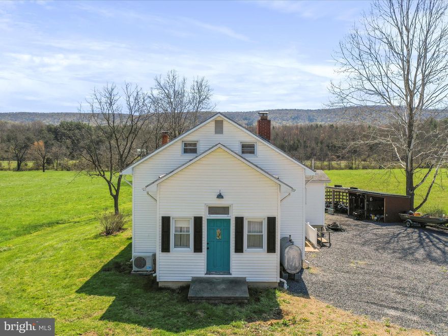 Charming Country Schoolhouse with Mountain Views and Creekside Serenity – Perfect for Airbnb!

Welcome to this one-of-a-kind home, a charming piece of history! Originally built in 1876 as a country schoolhouse, this 3-bedroom, 2-bathroom property seamlessly blends vintage character with modern comforts. With 1,876 square feet of living space and set on nearly half an acre (.49), this home offers expansive mountain views and the soothing sounds of Dry Run Creek, which borders the property. Imagine relaxing on the rear deck, listening to the gentle flow of the water!

Key Features:

Unique History & Charm: Built as a country schoolhouse, this home retains its historic character while offering modern living spaces.

Spacious Living Areas: The main level features a large living room, a country kitchen with ample room for gatherings, a cozy dining room, and a sunny sunroom just off the kitchen – perfect for relaxing or enjoying your morning coffee.

Comfortable Bedrooms: Two spacious bedrooms and a full bath on the main level provide convenience and privacy. The upper level is home to the primary bedroom and bath, complete with a cozy sitting room for your personal retreat.

Expansive Basement: An unfinished basement provides incredible potential – with a workshop area, rough-in for a future bathroom, and plenty of room to expand for additional living space, storage, or a home gym.

Outdoor Paradise: The property offers beautiful views of the mountains and the creek, with the added benefit of a large lot, perfect for gardening, outdoor activities, or simply enjoying the natural beauty of the surroundings.

Storage & Future Potential: A dedicated room in the basement is perfect for storing canned goods, making it an ideal space for those who love gardening and homesteading. Additionally, the rough-in for a future bathroom and expansive space offer limitless possibilities for customization.

Efficient Heating & Cooling: Stay comfortable year-round with the home’s unique heating and cooling system. The property is equipped with an outdoor wood boiler system that not only provides warmth throughout the home but also heats the water for the water heater, ensuring cost-effective and sustainable living. Additionally, a mini-split system offers air conditioning for the warmer months, while also providing supplemental heat when needed.

Ideal for Airbnb: This property offers endless potential as a short-term rental! With its unique charm, scenic views, and peaceful creekside setting, it’s an ideal place for guests to escape and unwind. The spacious layout, serene atmosphere, and close proximity to local attractions make it perfect for Airbnb hosts looking to provide a memorable experience for visitors.

Located in a peaceful, picturesque setting with easy access to nature and close proximity to local amenities, this is more than just a house – it's a place to create lasting memories. Whether you're seeking a tranquil personal retreat or an investment property with Airbnb potential, this home offers endless opportunities.

Schedule your showing today!