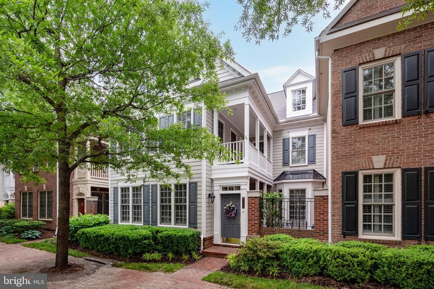 Welcome to the epitome of modern urban living where Charleston indoor/outdoor lifestyle meets Old Town Alexandria charm and grace. With almost 2800 sf of updated living space, this home is an entertainer's dream while at the same time offering intimate cozy spaces for every day living. Walk through the courtyard door and step into the welcoming brick patio perfect for hosting neighbors and welcoming guests. Impressive columns form the entry to the formal living room that overlooks the  front courtyard. An open bright living space with sparkling hardwood floors combined with 9 foot ceilings accented by crown moldings creates an air of comfort and design sophistication. The gracious dining room accented with chair rail, wainscoting and an elegant pendant light can accommodate large dinner parties with access to both the living room and the family room. The fireplace in the family room with surrounding built-in cabinets for display and storage as well as a bay window overlooking the front courtyard is the perfect place to settle in for a fun movie night or snuggle up and read your favorite book. Step through to the stunning gourmet kitchen with every amenity a chef could dream of - HUGE island with seating, custom white cabinets with lighted upper display, expansive granite counters with elegant leathered finish, chef's quality stainless steel appliances including a double wall oven and six burner gas range.  Entertain and enjoy every day meals with views through the glass door to another private patio (with a built-in gas line).  Just down the hall is a convenient laundry with built-in shelves and a huge walk-in pantry with custom shelving. Upstairs open the French doors into the primary suite - an incredible escape from the city! Soaring cathedral ceilings, room to accommodate a king bed and multiple seating areas including a private balcony that overlooks the courtyard below. This exceptional primary suite includes a spa bath that rivals a chic boutique hotel with double vanities, separate water closet, an oversized tile shower with custom glass enclosure, soaking tub and then two HUGE walk-in closets both with custom organization. The second bedroom also has soaring cathedral ceilings, multiple large closets with organizers, and a French door to a Juliet balcony that opens to community views. The third bedroom is the perfect home office or exercise space - whatever compliments your lifestyle. The updated shared hall bath has a dual granite vanity and a separate toilet/shower room great for accommodating guests. A two car rear entry garage with shelving provides needed extra storage space. 

Old Town Village is the ideal city community with all the suburban amenities you could want - a saltwater pool, clubhouse with meeting space, library, gym, and community events. Just four blocks from King Street's eclectic shops and acclaimed restaurants, only a quick walk to Metro and Whole Foods, and a fun stroll to active nightlife along the riverfront - everything to do and see is just outside your front door! Ready to move in and start enjoying your Old Town life? This is the one for you!