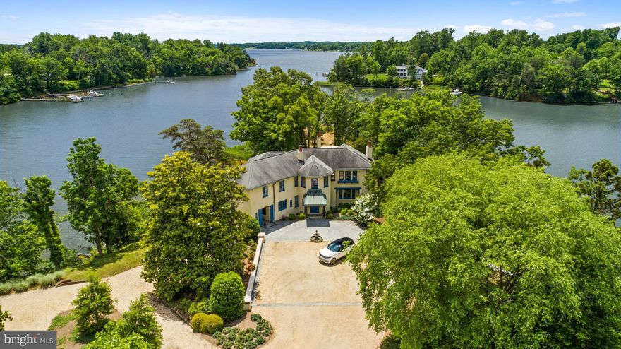 Welcome to Homeport Manor, a hidden treasure on the serene waters of Church Creek, just off the South River. Nestled on nearly 6.5 acres, this unique Annapolis estate, also known as Davis Point, offers unparalleled privacy and beauty. As you pass through the gate, a quarter-mile winding driveway unfolds, leading you to an exquisite home where every window expertly frames captivating water vistas. Perfectly sited and presiding over 1,800 ft of pristine living shoreline, this property is a rare find. Originally built in 1933, this 7,200-square-foot manor has been meticulously updated while preserving its historic charm. From the restored stone and woodwork, plaster ceilings and walls, original trim and doors and fully modernized with geothermal heating and air-conditioning, this home seamlessly blends the past with the present. The heart of the home, the kitchen, is a chef’s dream. Thoughtfully renovated, it features two sinks with disposals, two refrigerators, two dishwashers, a dual oven with an 8-burner gas system, a wine refrigerator, new cabinetry, radiant heated flooring, and a spacious walk-in pantry. Every detail speaks of luxury and practicality. Entertaining is effortless with expansive living spaces that have hosted hundreds. The flow of indoor/outdoor living makes gatherings both large and small a wonderful experience for the host and guests. Upstairs, the two primary bedroom suites are each luxurious in their own way. Equal in their endless water views, one features a nostalgic sleeping porch and the other boasts a steam shower and radiant heated floors. The home's bathrooms have been renovated to maintain their timeless elegance, complete with original cast iron tubs and stunning marble accents.  Each of the five bedrooms offer ensuite baths to ensure convenience and privacy for family and friends. Unique features abound in this manor, from the three wood-burning fireplaces and built-in wall safes, to the Prohibition-era gentleman's lounge in the basement and a wine cellar that can hold over 300 bottles.  Outdoors, the property continues to impress. The deep water private pier, with 6 ft MLW is suitable for almost any vessel and the reconstructed boathouse is perfect for kayak storage and other boating accessories. Located in the ideal location for quickly accessing the South River or Chesapeake Bay by boat, heading by car to Historic Annapolis or hopping on Rt. 50 to get back to Washington, DC. Tranquility meets convenience, making it the ultimate retreat for those seeking the best of waterfront living. Welcome Home!