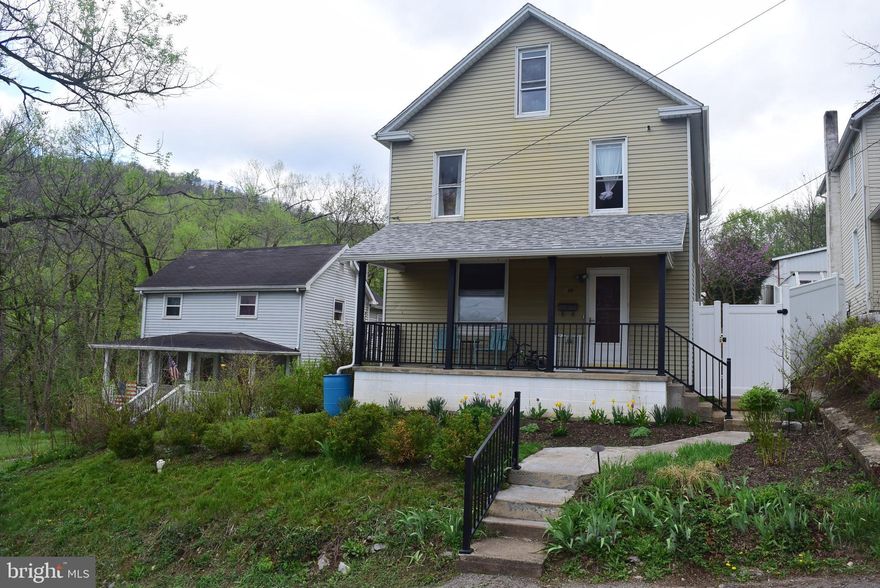 Offering approximately 1,500 square feet of above-grade living space, this charming Bellefonte home combines timeless character with practical updates and inviting outdoor space. Beautiful hardwood floors flow throughout most rooms, accented by original wide trim, and a beautiful staircase that showcase the home's classic appeal.

The ceramic tile kitchen includes a convenient movable island and connects to a functional mudroom/laundry area with direct access to the backyard. The location of the laundry room also makes adding a first-floor half bath an easy future project.

The second floor features a spacious owner's bedroom, a full bath, and two additional bedrooms, including one captive room ideal for a nursery, or guest space.

Storage is plentiful with a large floored walk-up attic and a partial unfinished walk-up basement. 

Situated on a 0.20-acre lot, the property features a fully vinyl-fenced backyard complete with a patio and fire pit, creating the perfect setting for relaxing evenings and outdoor entertaining.  Gravel parking area at the rear of the lot plus two on-street parking spaces directly in front of the home.

Recent improvements include a new porch roof and railings, new gutters, and a new water heater. A professional survey has also been recently completed for added peace of mind. The home is served by forced-air heat, public sewer, and public water.

With its blend of historic charm, generous storage, and inviting outdoor space, this affordable Bellefonte home is ready for its next chapter.