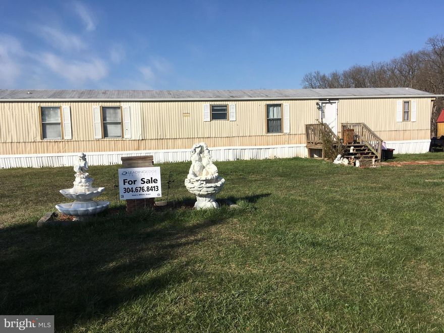 Mobile home on 5 acres.  The 3 ac. lot has access to public sewer, build your home on this lot and have rental income from mobile home and 2 acres.  Mobile home is currently rented at $700.00 month.  Please allow at least 24 hour notice when showing property.