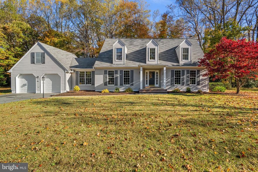 Welcome to this charming Twin Hills colonial! Thoughtfully updated and beautifully maintained, this home offers space, privacy, and comfort on a 1.8-acre wooded lot tucked at the end of a quiet cul-de-sac in Annapolis. The welcoming foyer sets the tone as you step inside, where large, comfortable rooms create the perfect balance of openness and privacy—ideal for both everyday living and entertaining. The entire main level was upgraded with durable vinyl flooring in April 2022, providing a cohesive, modern feel throughout. The front office offers a quiet work-from-home space, while the light-filled living room and formal dining room provide inviting areas to gather. The kitchen features ample counter space, abundant cabinet and pantry storage, and updated appliances, including a GE Profile refrigerator and dishwasher (2024). A bright breakfast nook flows seamlessly into the adjacent family room with fireplace, creating a warm and functional heart of the home. A convenient half bath and fresh interior paint throughout complete the main level. Upstairs, the spacious primary suite offers a peaceful retreat with a walk-in closet and en-suite bath with soaking tub, dual vanity, and separate shower. Two additional bedrooms and a full hall bath complete the upper level. The unfinished walkout lower level presents endless potential to customize, with a rough-in already in place for a future full bath. Exterior improvements further enhance the home’s curb appeal, including freshly painted shutters, trim, and front door, PVC garage door trim, and newly painted garage doors. The new deck (2025) and covered front porch extend the living space outdoors—perfect for enjoying the expansive yard and wooded backdrop. Additional highlights include a two-car garage with driveway parking (driveway replaced in 2023), private well with a biannually serviced water treatment system, and additional crawl space storage. Located just five minutes from shopping, dining, and major commuter routes, this property offers the rare combination of privacy and convenience. Whether hosting guests or savoring quiet evenings at home, this Twin Hills gem provides the perfect backdrop for every occasion. Schedule your private tour today!
